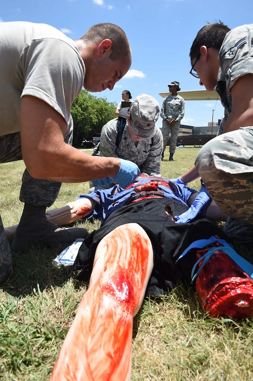 Medics from the 59th Medical Wing triage a patient during a disaster response exercise July 13, 2016 at Camp Bramble on Joint Base San Antonio-Lackland, Texas. The exercise simulated an aircraft crash designed to test the medics’ response skills in the event of a similar real-world incident. (U.S. Air Force photo/Staff Sgt. Jerilyn Quintanilla)