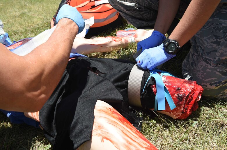 A medic from the 59th Medical Wing applies a tourniquet on a simulated patient during a July 13, 2016 disaster response exercise at Camp Bramble on Joint Base San Antonio-Lackland, Texas. The exercise simulated an aircraft crash designed to test the medics’ response skills in the event of a similar real-world incident. (U.S. Air Force photo/Staff Sgt. Jerilyn Quintanilla)