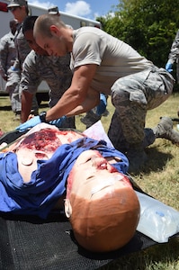 Medics from the 59th Medical Wing triage a patient during a disaster response exercise July 13, 2016 at Camp Bramble on Joint Base San Antonio-Lackland, Texas. The exercise simulated an aircraft crash designed to test the medics’ response skills in the event of a similar real-world incident. (U.S. Air Force photo/Staff Sgt. Jerilyn Quintanilla)