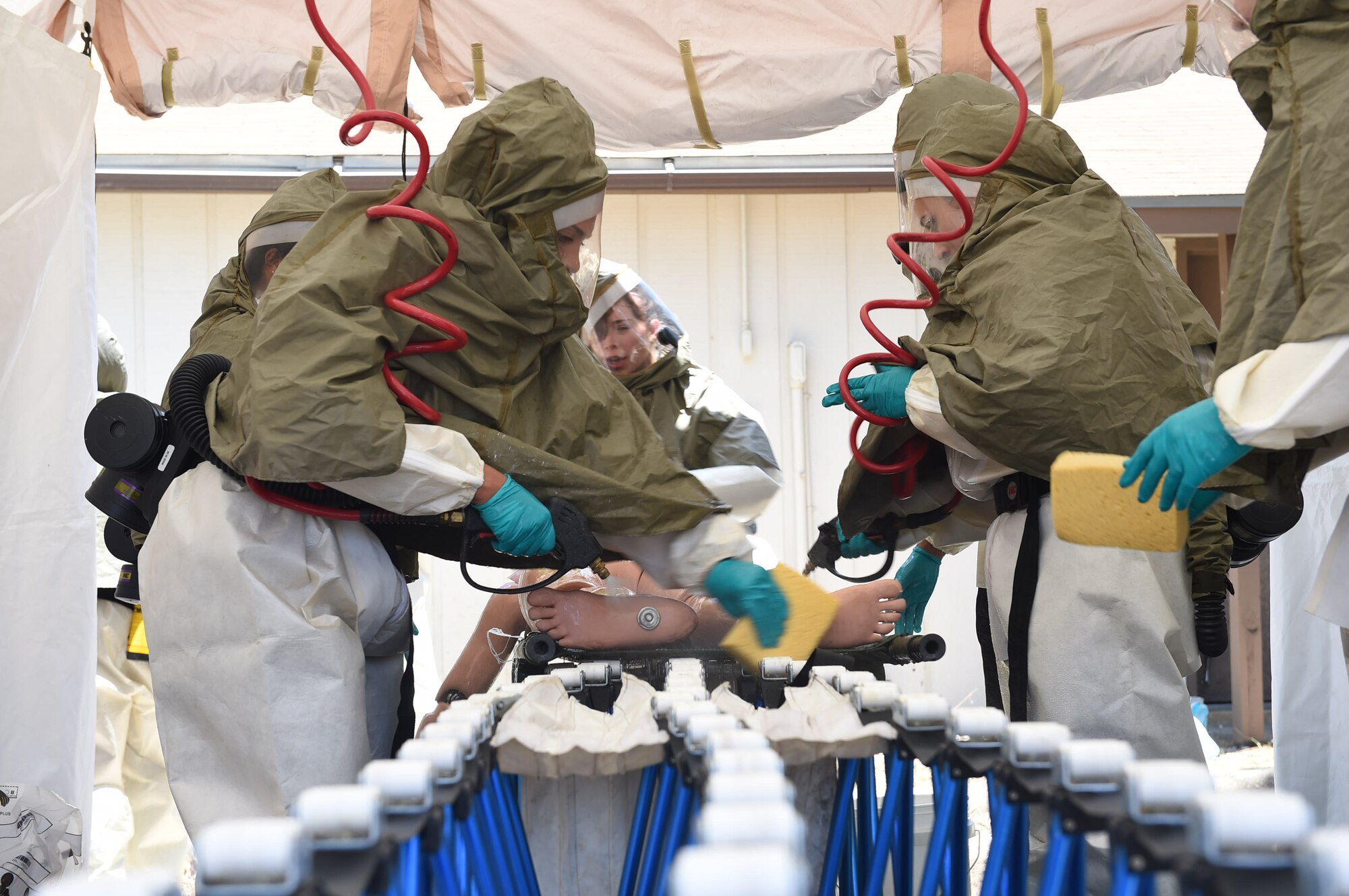 Disaster response team members move simulated patients through a decontamination station during a July 13, 2016 exercise at Camp Bramble on Joint Base San Antonio-Lackland, Texas. The exercise simulated an aircraft crash designed to test the medics’ response skills in the event of a similar real-world incident. (U.S. Air Force photo/Staff Sgt. Jerilyn Quintanilla)