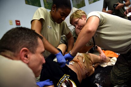 Warrior medics from 59th Medical Wing treat a patient suffering from simulated injuries during a July 13, 2016 disaster response training exercise at Camp Bramble on Joint Base San Antonio-Lackland, Texas. The exercise, which simulated an aircraft crash, was designed to test the medics’ response skills in the event of a similar real-world incident. (U.S. Air Force photo/Staff Sgt. Jerilyn Quintanilla) 