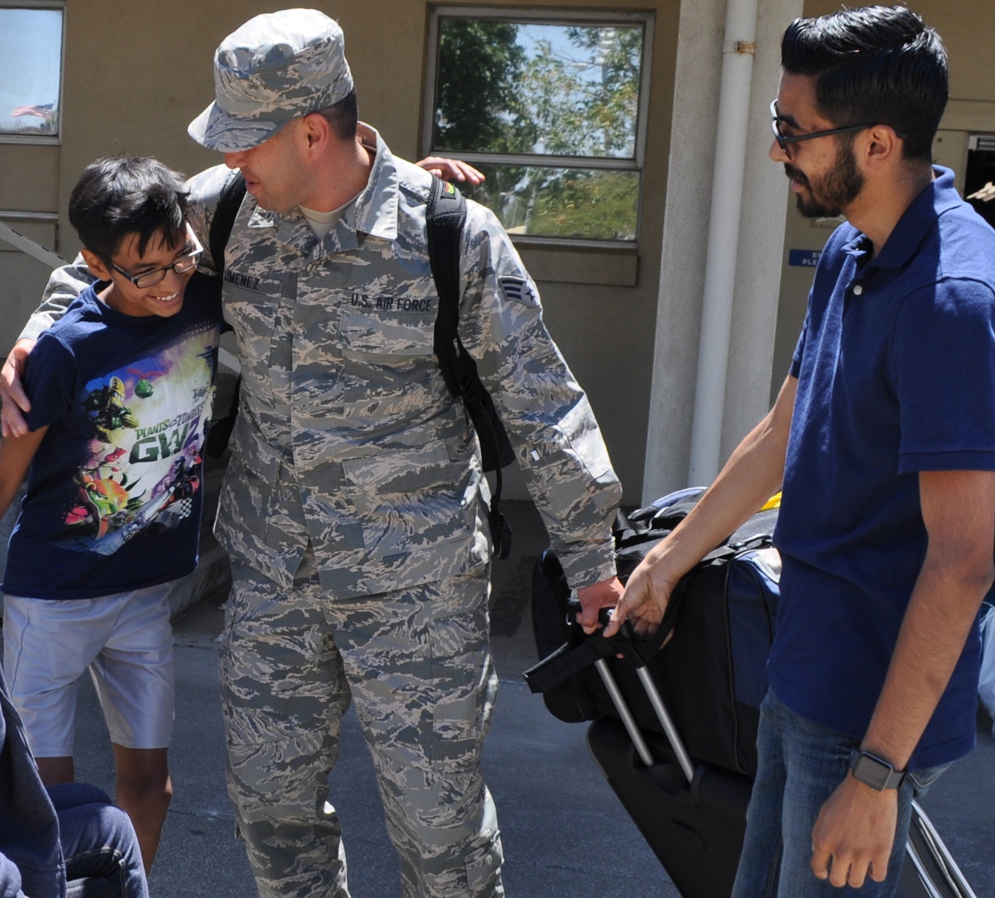 Returning from an overseas tour of duty with the 349th Logistics Readiness Squadron, Senior Airman Jesse Jimenez is greeted enthusiastically by his wife and children at the Travis Air Force Base passenger terminal July 2, 2016. (U.S. Air Force photo/Ellen Hatfield) 