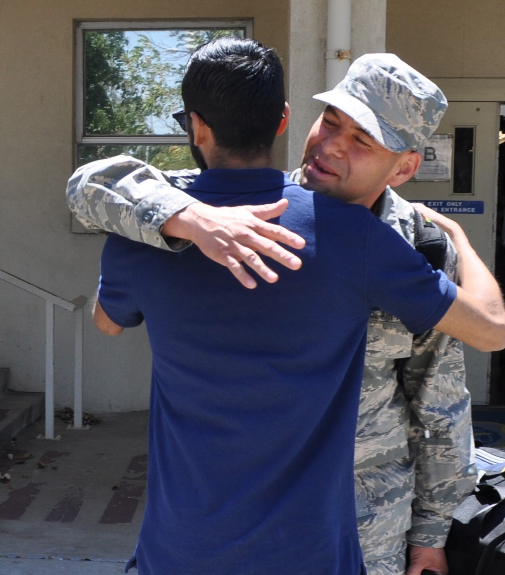 Returning from an overseas tour of duty with the 349th Logistics Readiness Squadron, Senior Airman Jesse Jimenez is greeted enthusiastically by his wife and children at the Travis Air Force Base passenger terminal July 2, 2016. (U.S. Air Force photo/Ellen Hatfield) 