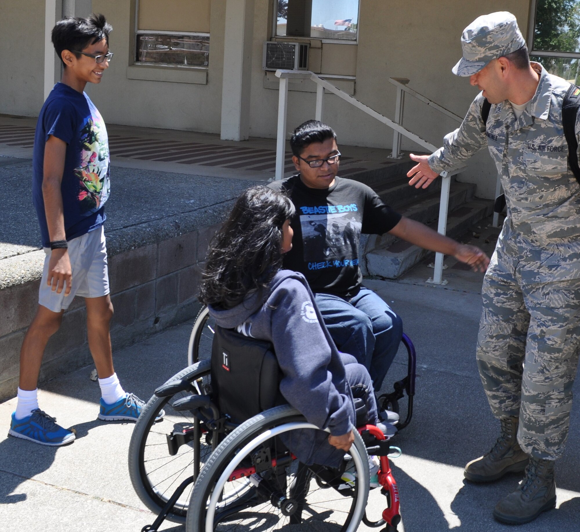 Returning from an overseas tour of duty with the 349th Logistics Readiness Squadron, Senior Airman Jesse Jimenez is greeted enthusiastically by his wife and children at the Travis Air Force Base passenger terminal July 2, 2016. (U.S. Air Force photo/Ellen Hatfield) 