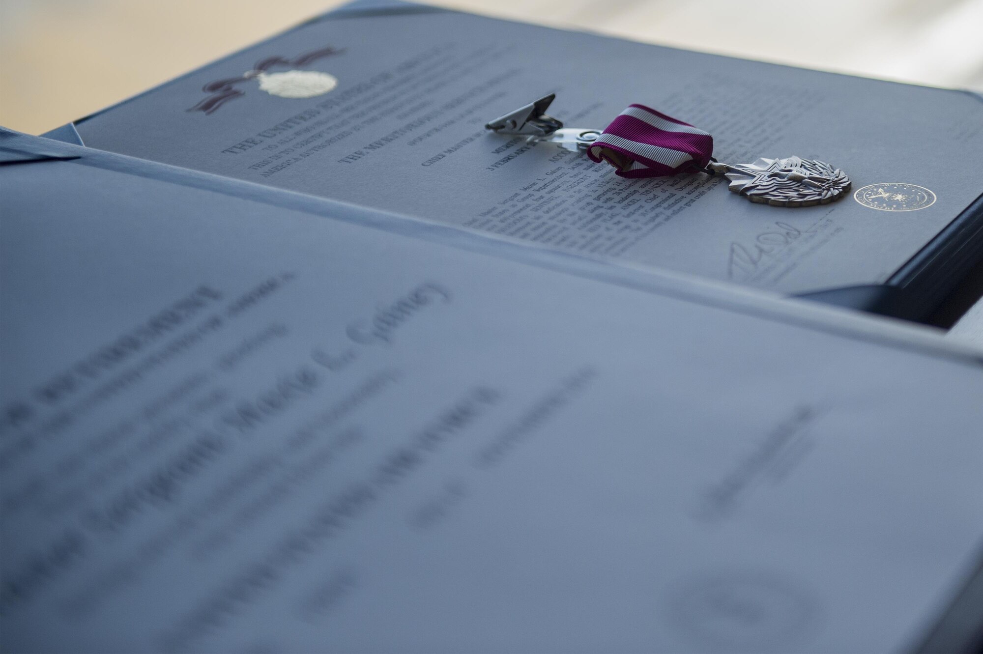 A Meritorious Service medal sits on the citation for Chief Master Sgt. Maxie Gainey, 347th Rescue Group chief enlisted manager, during a retirement ceremony, July 15, 2016, at Moody Air Force Base, Ga. Gainey entered the U.S. Air Force in the logistics career field and later became a loadmaster for C-130 aircraft. (U.S. Air Force photo by Tech. Sgt. Zachary Wolf)