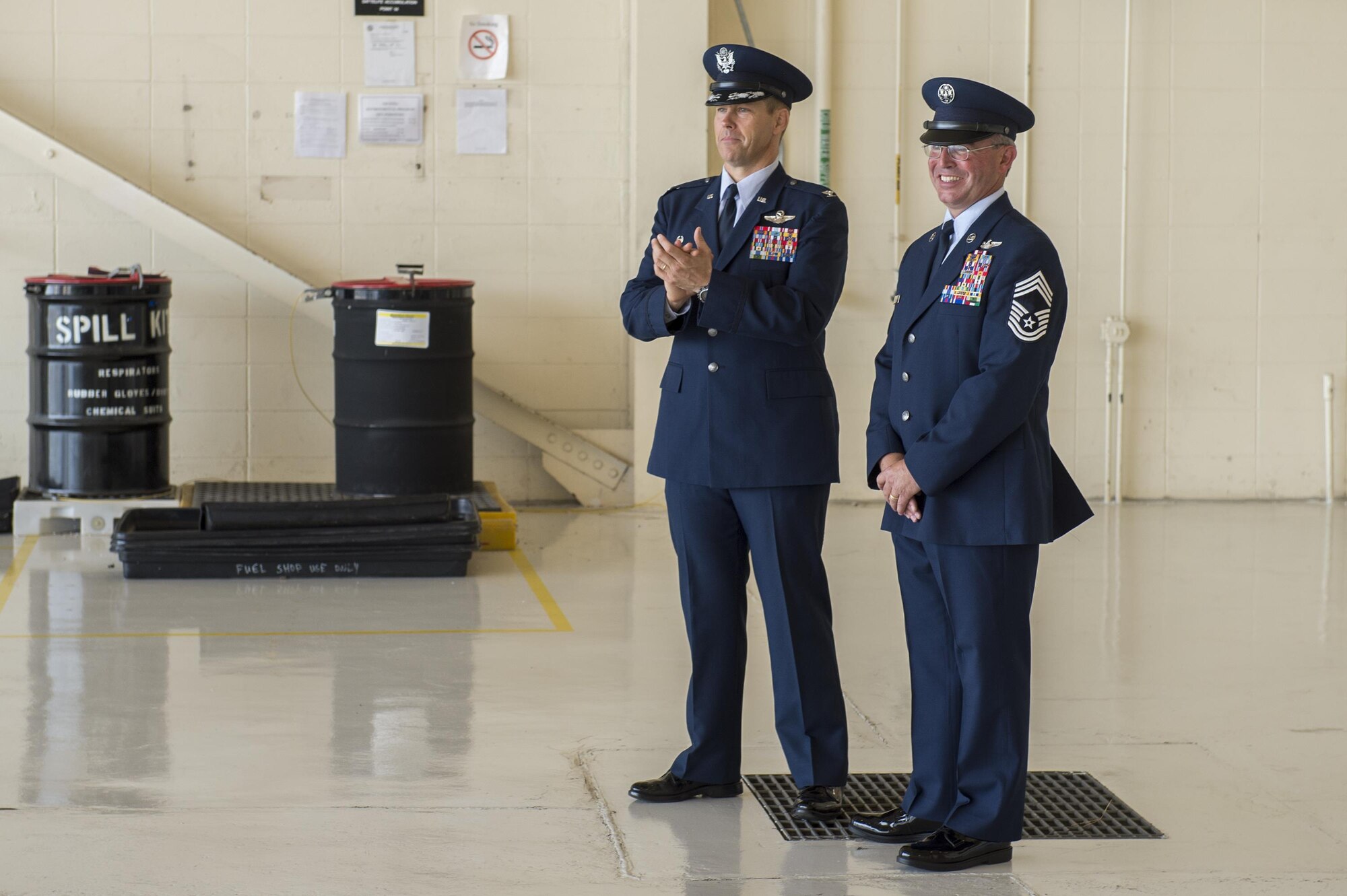 U.S. Air Force Col. Thomas Dorl, 347th Rescue Group commander, and Chief Master Sgt. Maxie Gainey, 347th RQG chief enlisted manager, prepare to take the stage during a retirement ceremony, July 15, 2016, at Moody Air Force Base, Ga. Gainey, as a chief enlisted manager, advised the commander with operational plans, policies and requirements affecting nearly 450 enlisted Airmen in four different squadrons. (U.S. Air Force photo by Tech. Sgt. Zachary Wolf)
