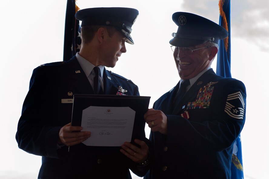 U.S. Air Force Col. Thomas Dorl, 347th Rescue Group commander, and Chief Master Sgt. Maxie Gainey, 347th RQG chief enlisted manager, share a laugh during a retirement ceremony, July 15, 2016, at Moody Air Force Base, Ga. Gainey entered the Air Force as a logistics management specialist and supported various aircraft including the T-38 Talon, SR-71 Blackbird and U-2 Dragon Lady. (U.S. Air Force photo by Tech. Sgt. Zachary Wolf)
