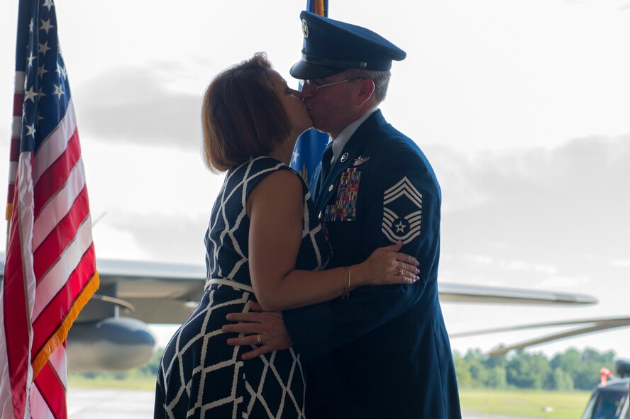 U.S. Air Force Chief Master Sgt. Maxie Gainey, 347th Rescue Group chief enlisted manager, kisses his wife, Mishelle, during his retirement ceremony, July 15, 2016, at Moody Air Force Base, Ga. Gainey has been married for 26 years and has two daughters, Ariel and Brittany. (U.S. Air Force photo by Tech. Sgt. Zachary Wolf) 
