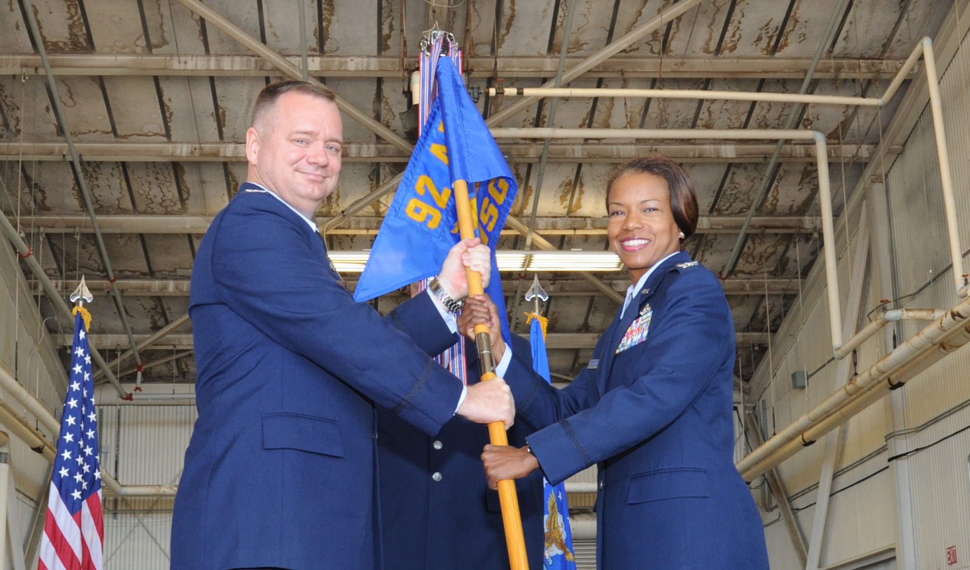 Col. Brian McDaniel, 92nd Air Refueling Wing commander, passes the 92nd Mission Support Group guidon to Col. Yvonne Spencer, 92nd MSG commander, during the change of command ceremony July 14, 2016, at Fairchild Air Force Base, Wash. Spencer was previously commander of the 819th RED HORSE Squadron at Malsmstrom AFB, Mont. (U.S. Air Force photo/Senior Airman Sam Fogleman)