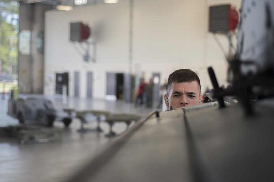 U.S. Air Force Airman 1st Class Jacob Wiemers, 75th Aircraft Maintenance Unit load crew member, inspects a missile latch on an A-10C Thunderbolt II during a load competition, July 15, 2016, at Moody Air Force Base, Ga. Load members must ensure munitions are safe, serviceable and properly configured. (U.S. Air Force Photo by Airman Daniel Snider) 