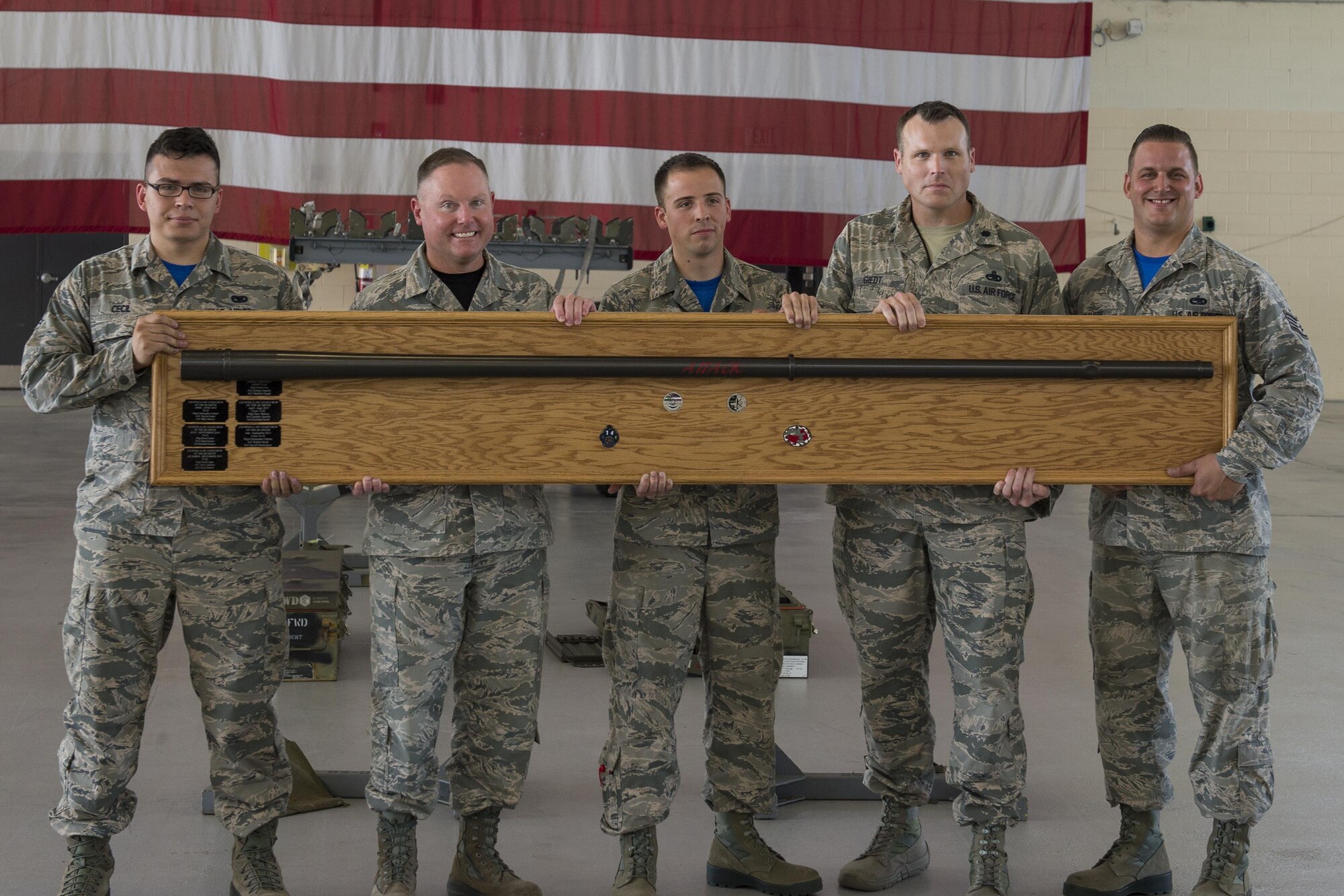 U.S. Air Force Airmen from the 74th Aircraft Maintenance Unit receive an award for winning a weapons load competition, July 15, 2016, at Moody Air Force Base, Ga. Although the 75th AMU completed their task faster, after a review of strategy and discrepancies, the 74th AMU won the competition. (U.S. Air Force Photo by Airman Daniel Snider)
