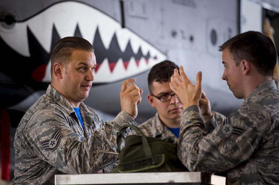 U.S. Air Force Staff Sgt. Dayton Gravlee, left, 74th Aircraft Maintenance Unit load crew member, briefs his team prior the start of a weapons load competition, July 15, 2016, at Moody Air Force Base, Ga. Gravlee served as his team’s chief, also known as a one-man, and his primary job was to review checklist procedures, empower his teammates and ensure the load went smoothly. (U.S. Air Force photo by Senior Airman Ryan Callaghan)