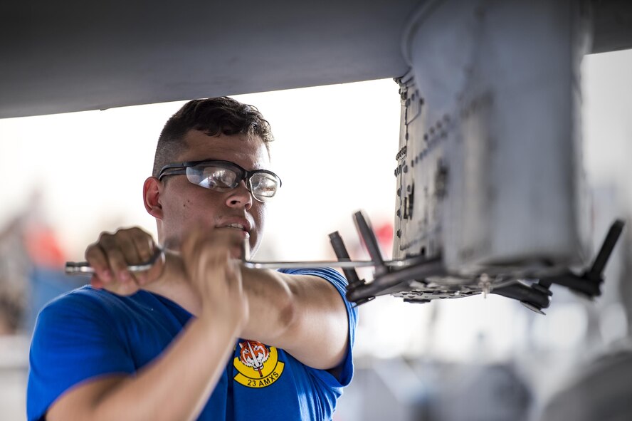 U.S. Air Force Senior Airman Elijah Cecil, 74th Aircraft Maintenance Unit load crew member, installs impulse cartridges during a weapons load competition, July 15, 2016, at Moody Air Force Base, Ga. Aside from being named the best load crew of the quarter, the crew showcased the 23d Wing's mission capabilities, while putting on a show for dozens of co-workers and guests. (U.S. Air Force photo by Senior Airman Ryan Callaghan)