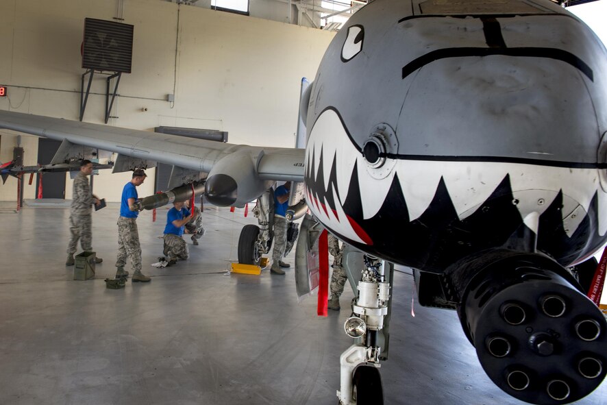 A weapons load crew from the 74th Aircraft Maintenance Unit secures training munitions on an A-10C Thunderbolt II during a weapons load competition, July 15, 2016, at Moody Air Force Base, Ga. The load crew from the 74th AMU raced against a team from the 75th AMU and, ultimately, won the competition after judges and evaluators tallied their scores. (U.S. Air Force photo by Senior Airman Ryan Callaghan)