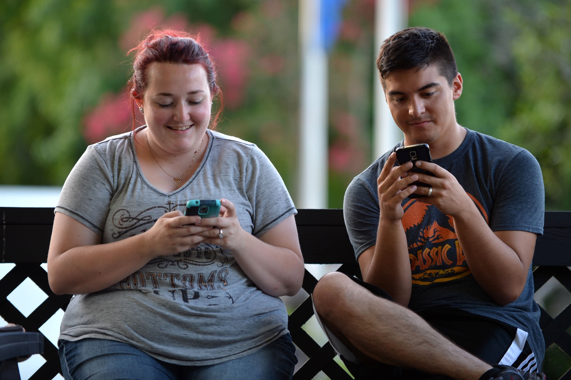 (From left) Melissa Bean and U.S. Air Force Airman Brendon Bean, 20th Aircraft Maintenance Squadron avionics technician, play Pokémon Go at Memorial Lake on Shaw Air Force Base, S.C., July 12, 2016. Pokémon Go is a new app taking the country by storm and has become the most downloaded game on smartphones after its release. (U.S. Air Force photo by Senior Airman Michael Cossaboom)