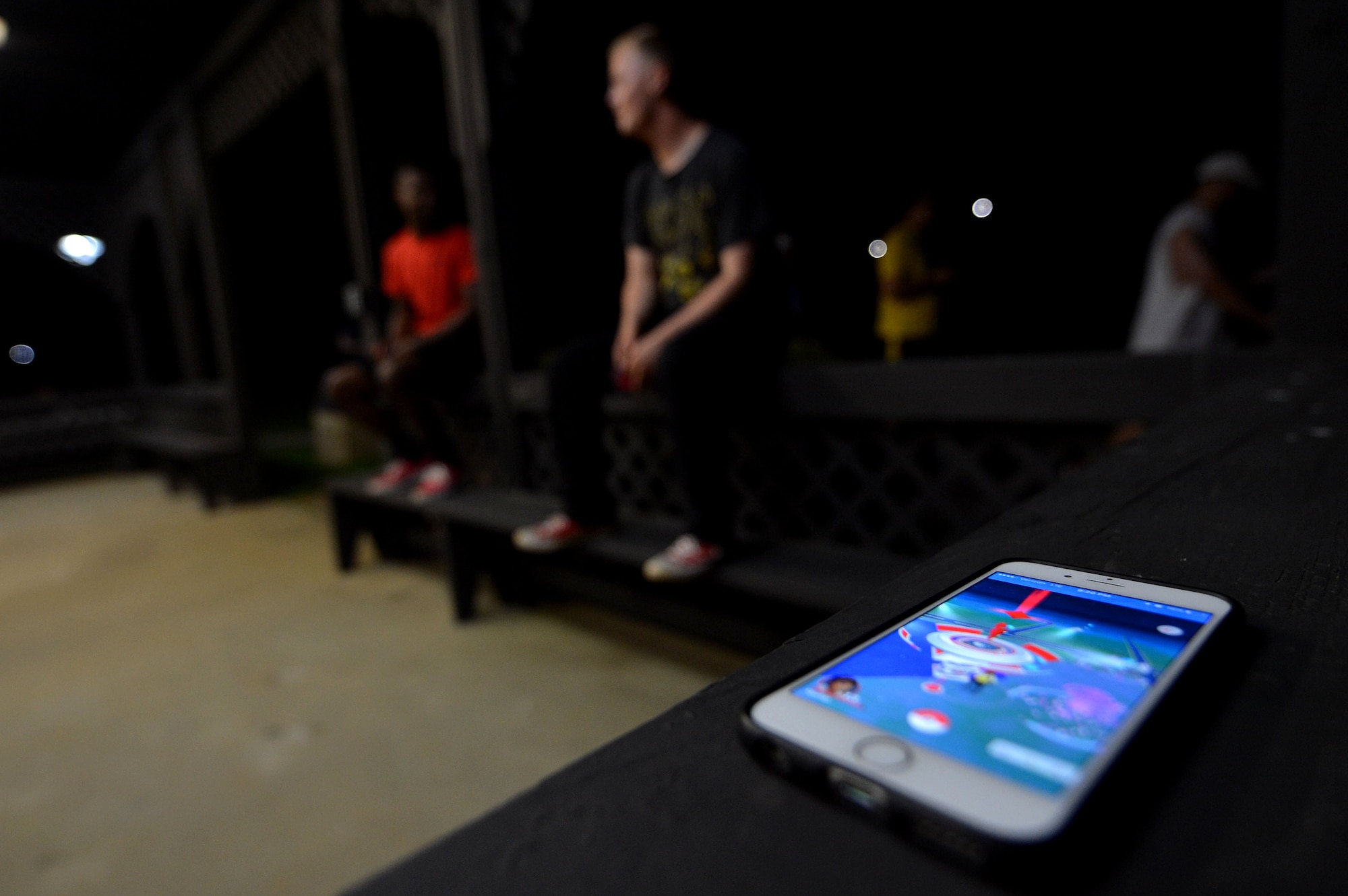 An iPhone is laid on a bench at Memorial Lake on Shaw Air Force Base, S.C., July 12, 2016. The new game Pokémon Go has given Airmen and Soldiers common ground for an opportunity to foster new relationships on base. (U.S. Air Force photo by Senior Airman Michael Cossaboom)
