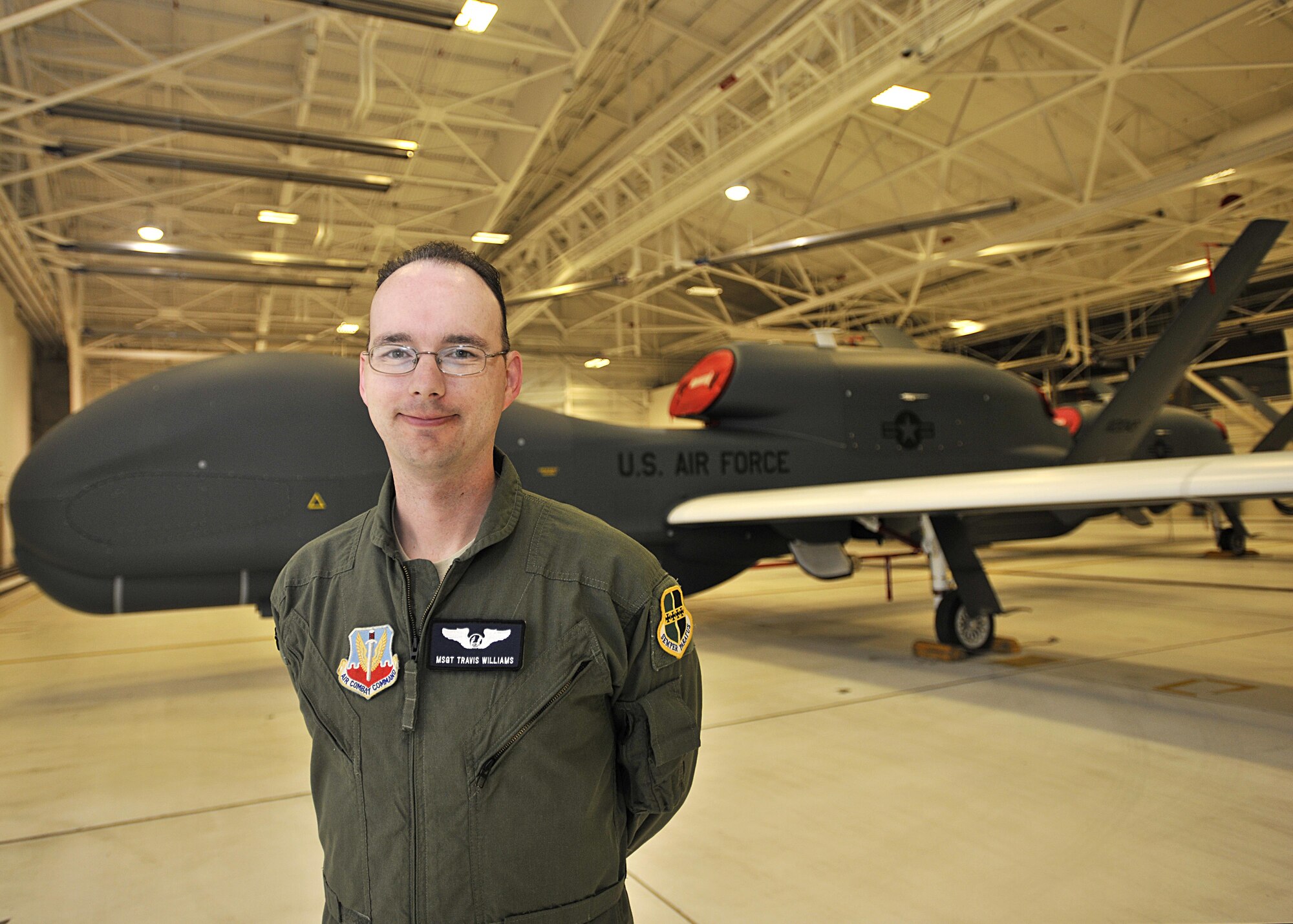 Master Sgt. Travis Williams, 69th Reconnaissance Group NCO-in-charge of group standards and evaluations, stands in front of an RQ-4 Global Hawk July 15, 2016, on Grand Forks Air Force Base, N.D. Williams is one of the 10 enlisted members who will go into Enlisted Pilot Initial Class in October 2016.  (U.S. Air Force photo by Senior Airman Xavier Navarro/Released)