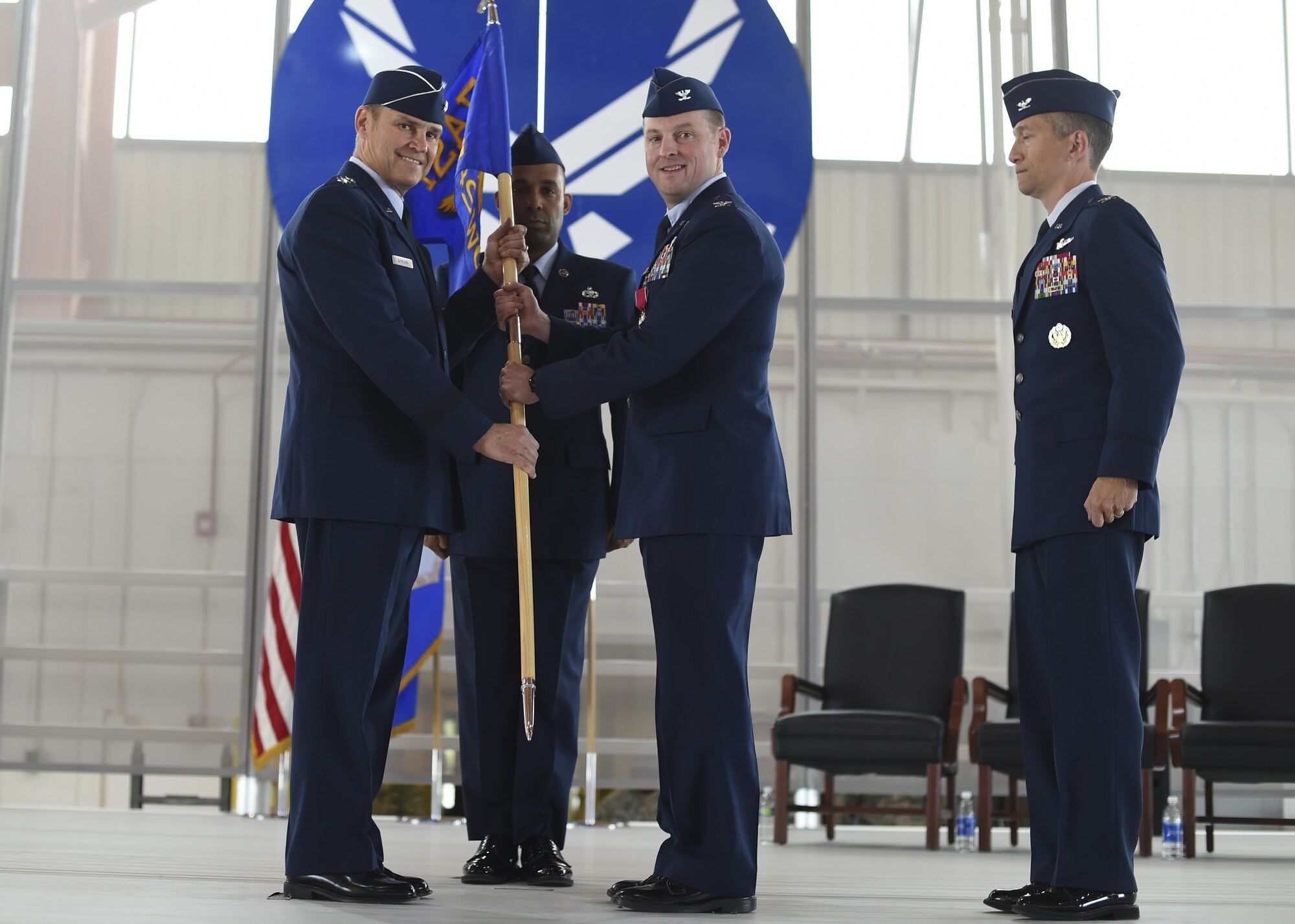 Lt. Gen. Mark Nowland the 12th Air Force commander receives the 49th Wing gidon from Col. Robert Kiebler during a change-of-command ceremony July 15 at Hangar 500 at Holloman Air Force Base N.M. Col. Houston Cantwell assumed command of the 49th Wing and Holloman Air Force Base from the previous commander, Col. Robert Kiebler. As commander of the 49th Wing, Cantwell will lead Holloman’s mission to provide combat-ready Airmen, train MQ-1 Predator and MQ-9 Reaper pilots and sensor operators, and hosts the 54th Fighter Group's F-16 Fighting Falcon pilot training mission, the 96th Test Group's high-speed test track mission and the German Air Force Flying Training Center. (U.S. Air Force Photo by: Staff Sgt. Stacy Moless)