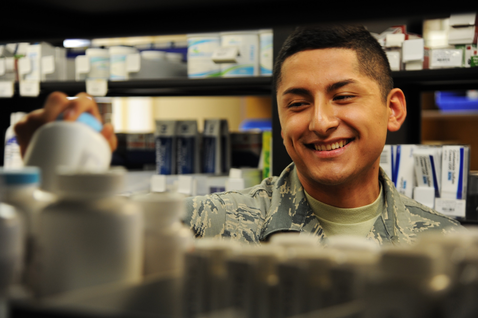 Airman 1st Class Alan Bustamante, a pharmacy technician assigned to the 6th Medical Group, restocks a shelf with prescription bottles at the PharmaCARE center at MacDill Air Force Base, Fla., July 12, 2016. The walk-in pharmacy fills approximately 700 to 1,000 prescriptions daily. (U.S. Air Force photo by Airman Adam R. Shanks)