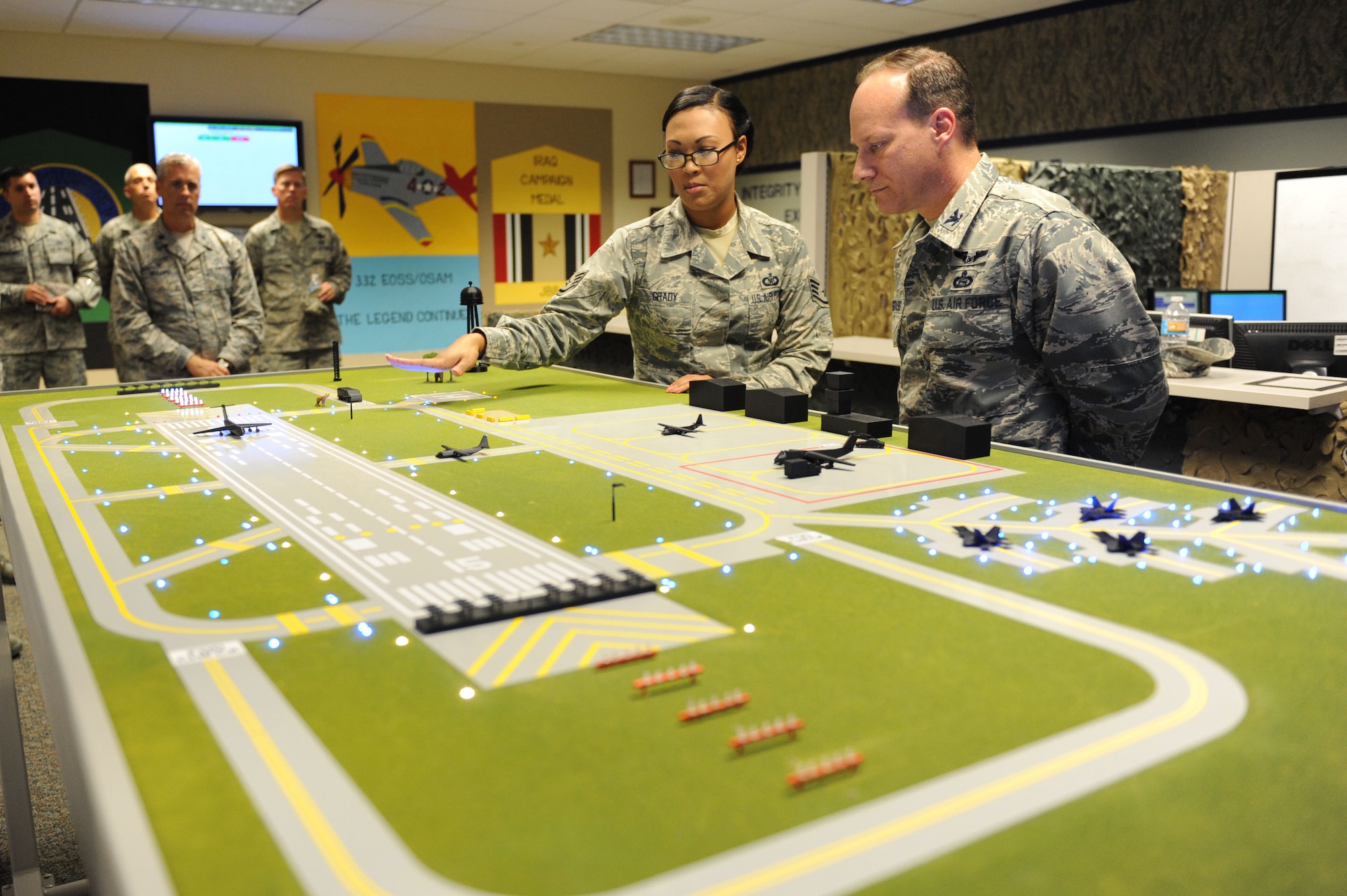 Staff Sgt. Shamena Grady, 334th Training Squadron instructor, briefs Col. Todd Weyerstrass, 2nd Air Force vice commander, on the air traffic control course at Cody Hall during an 81st Training Wing orientation tour July 12, 2016, on Keesler Air Force Base, Miss. The purpose of the tour was to become familiar with the wing’s mission, operations and personnel. (U.S. Air Force photo by Kemberly Groue/Released)