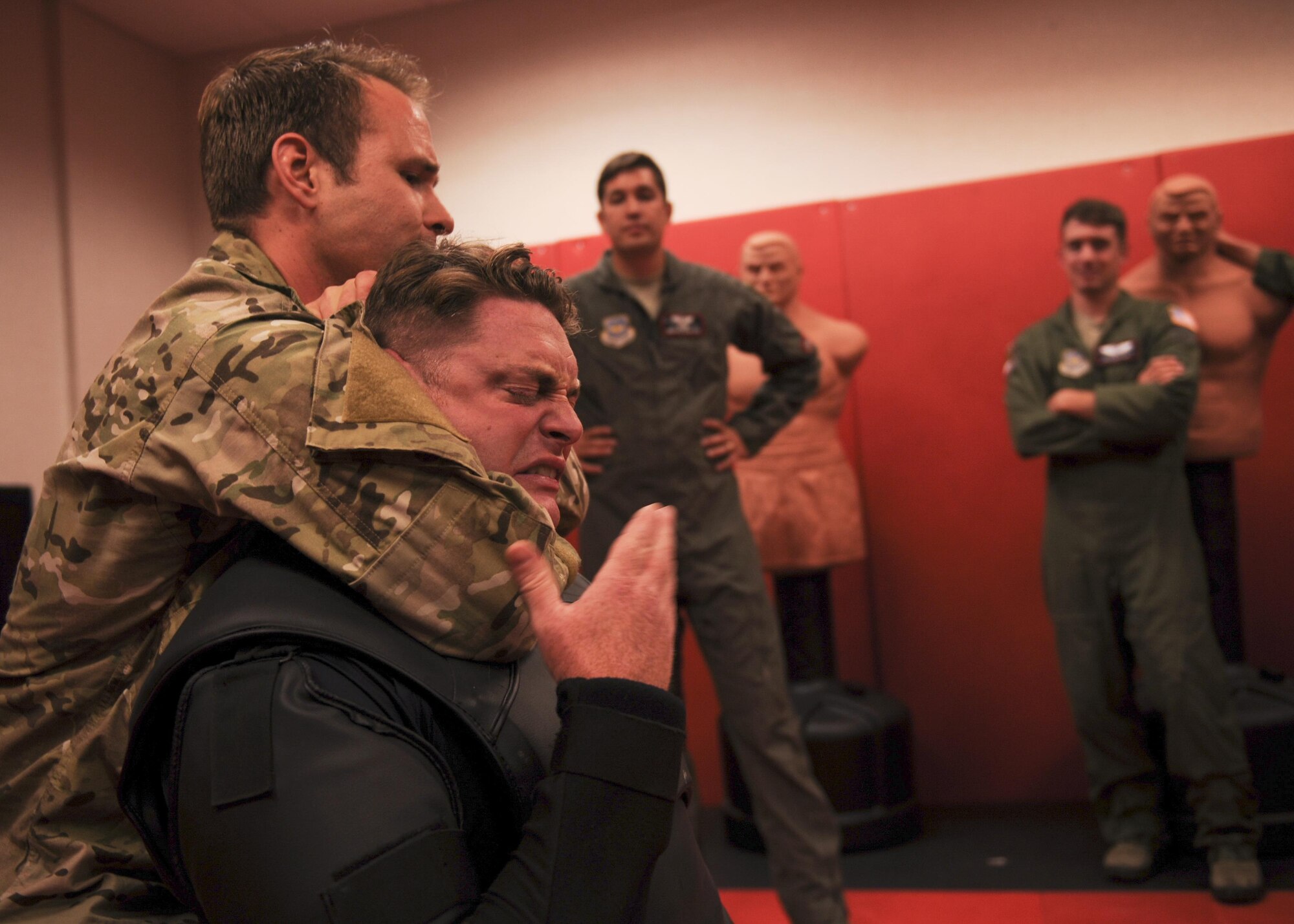 U.S. Air Force Tech. Sgt. Jerrod Mink and Master Sgt. Justin McCaffrey, 19th Operations Support Squadron survival, evasion, resistance and escape specialists demonstrate apprehension avoidance tactics to C-130J pilots from the 41st Airlift Squadron June 21, 2016, at Little Rock Air Force Base, Ark. Apprehension avoidance provides skills Airmen can use to maintain or regain their freedom.  (U.S. Air Force photo by Senior Airman Harry Brexel)