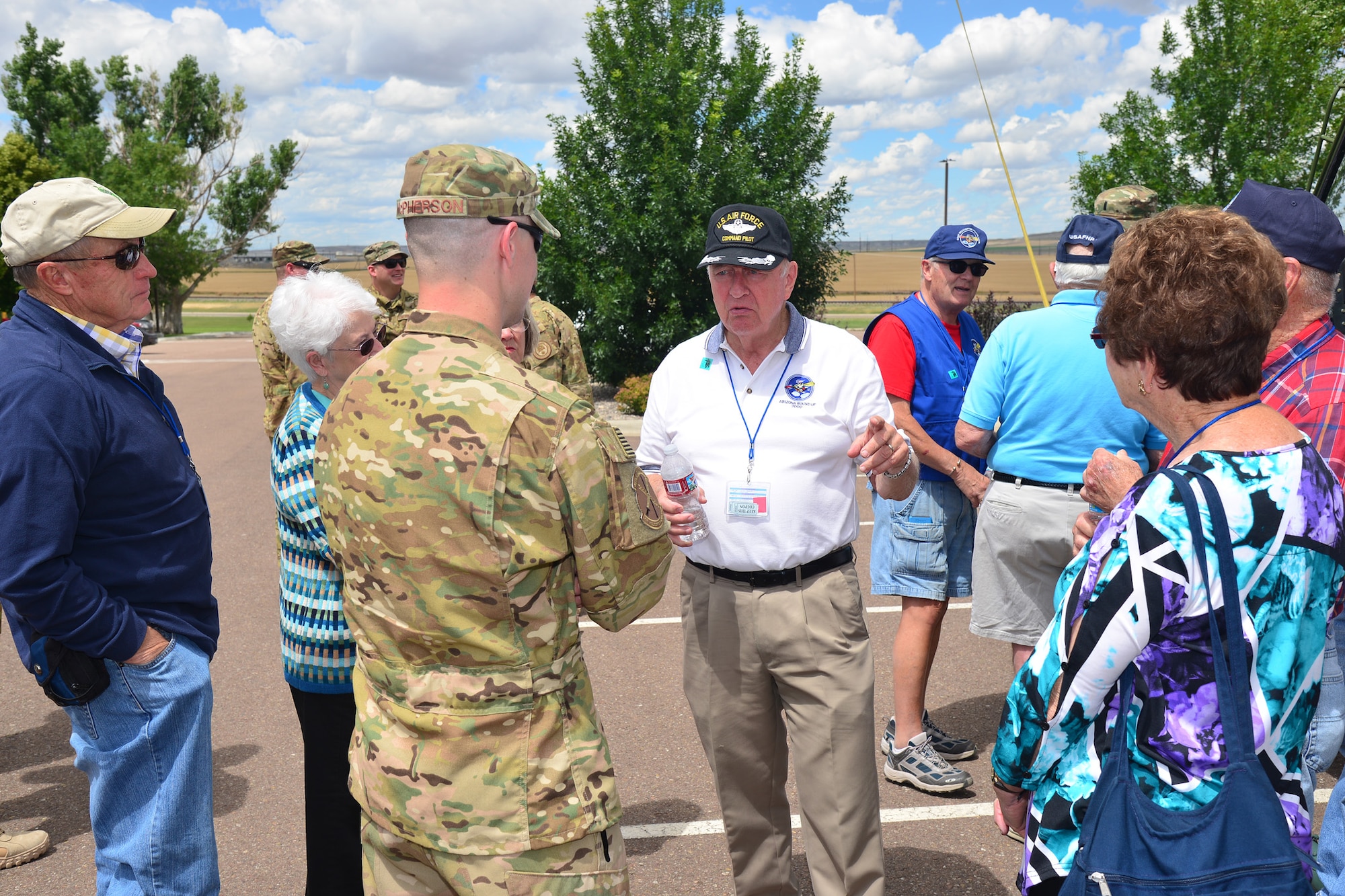 Maj. Jeremy McPherson, 40th Helicopter Squadron director of operations, center left, speaks with members from the United States Air Force Helicopter Pilot Association at Sun Plaza Park, July 14, 2016, at Malmstrom Air Force Base, Mont. The 40th HS provided a UH-1N Iroquois static display and stood by to answer questions for the guests. (U.S. Air Force photo/Airman 1st Class Daniel Brosam)