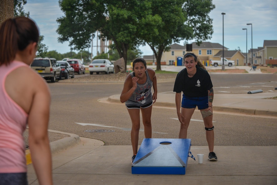 Air Commandos with the 27th Special Operations Maintenance Squadron compete in a cornhole round of Cannon Culture Day's "amazing race" July 8, 2016 at Cannon Air Force Base, N.M. The race included stations testing Air Commandos’ strength, knowledge, and multicultural awareness. 