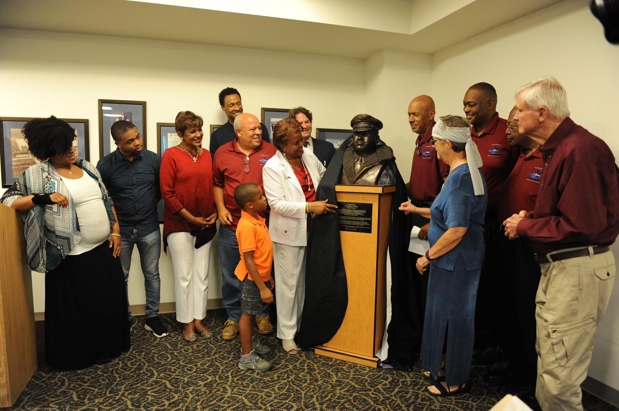 Family members and friends of Col. Lawrence E. Roberts, Tuskegee Airman, unveil a sculptured bust in his honor at the Gulfport-Biloxi International Airport July 13, 2016, Gulfport, Miss. Keesler personnel, family members, friends and community representatives gathered for the ceremony to honor Roberts, who began and ended his 32-year military career at Keesler. (U.S. Air Force photo by Kemberly Groue/Released)