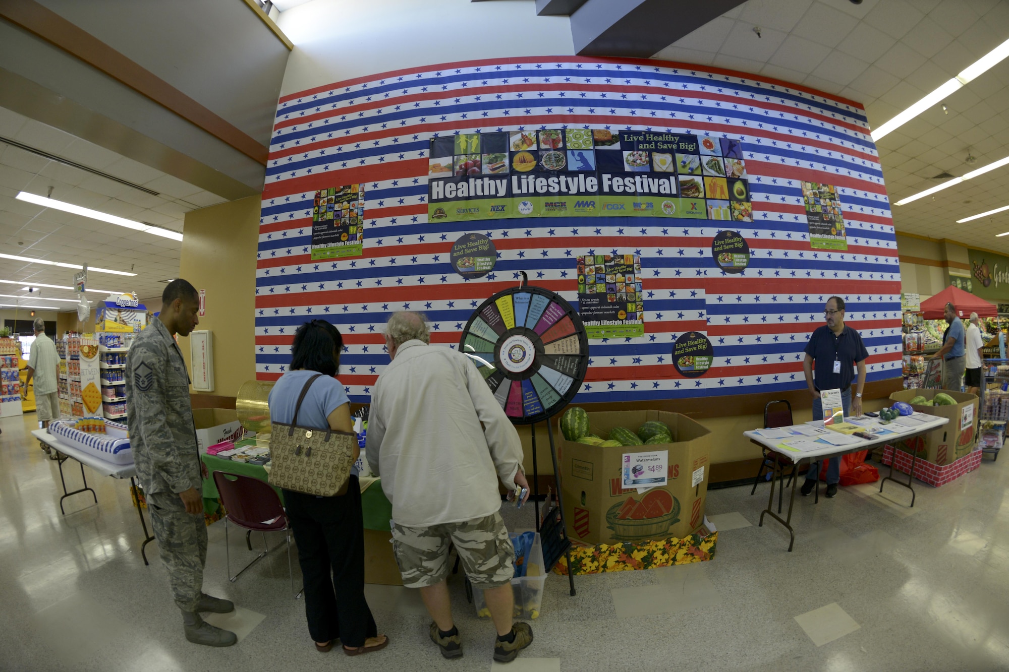 Commissary shoppers visit the Health and Wellness Center (HAWC) booth during the Healthy Lifestyle Festival at MacDill Air Base, Fla., July 15, 2016. The theme of the event was “Shop healthy, eat healthy and be healthy.”  (U.S. Air Force photo by Airman 1st class Mariette Adams)
