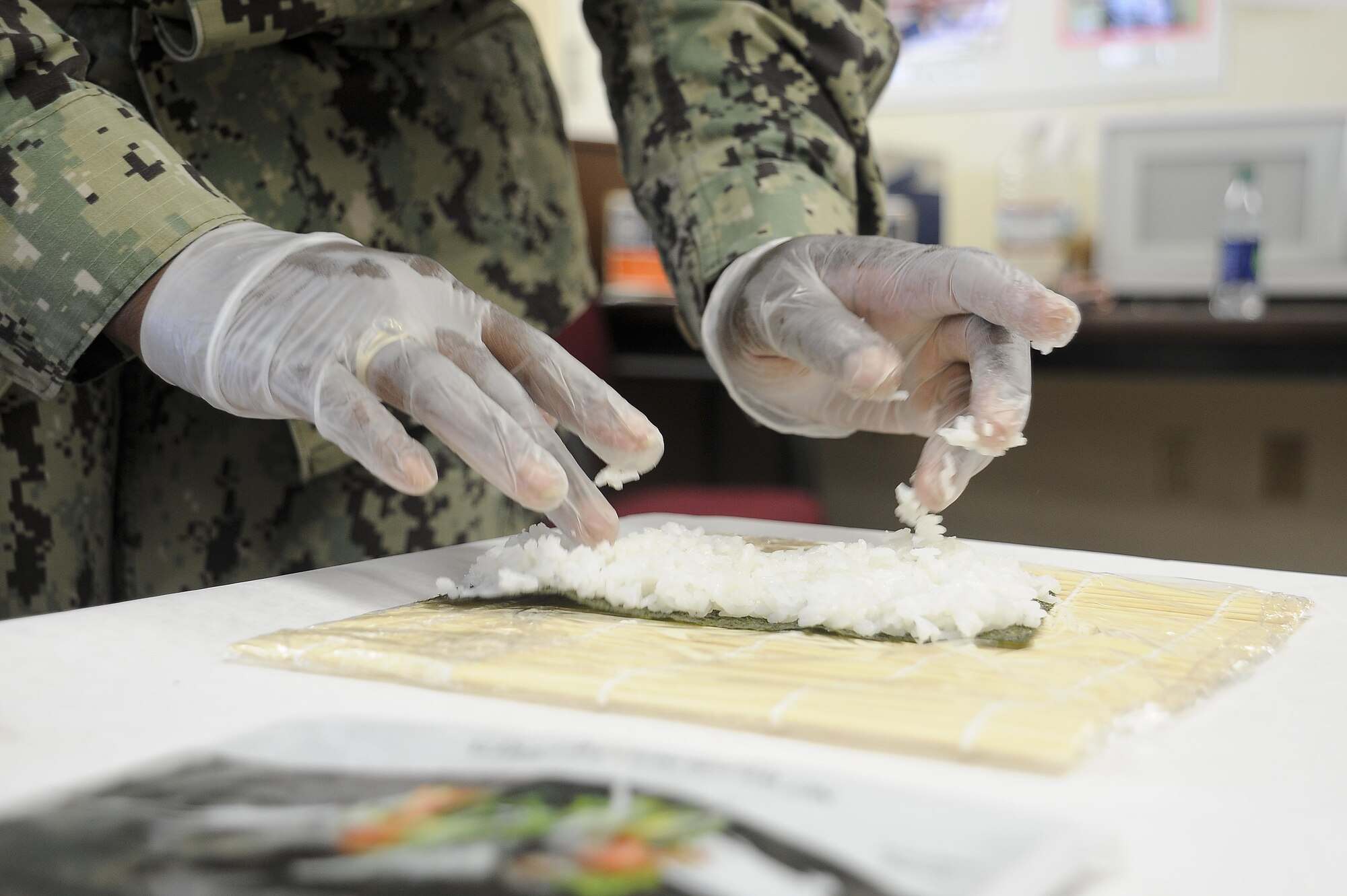 A service member makes sushi at the Healthy Lifestyle Festival at MacDill Air Base, Fla., July 15, 2016. The three day festival consisted of displays, a taste testing and raffles. (U.S. Air Force photo by Airman 1st class Mariette Adams)
