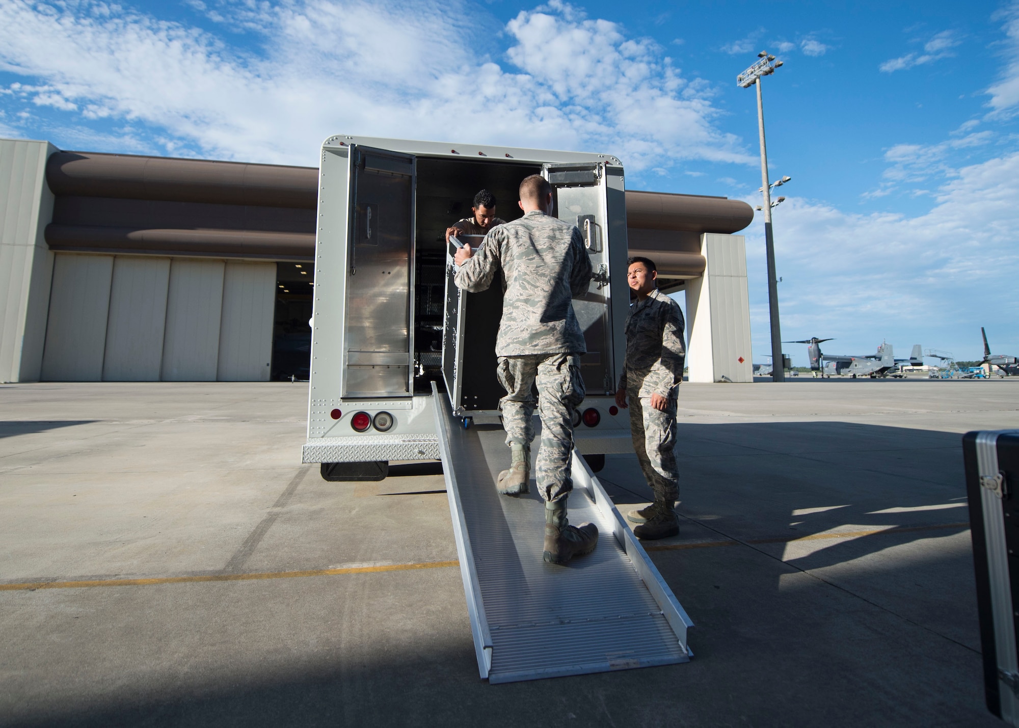 Radio frequency systems technicians with the 1st Special Operations Communication Squadron unload audio equipment at the Freedom Hangar on Hurlburt Field, Fla., July 15, 2016. 1st SOCS Airmen provide audio support for different ceremonies and events on base. (U.S. Air Force photo by Senior Airman Krystal M. Garrett)
