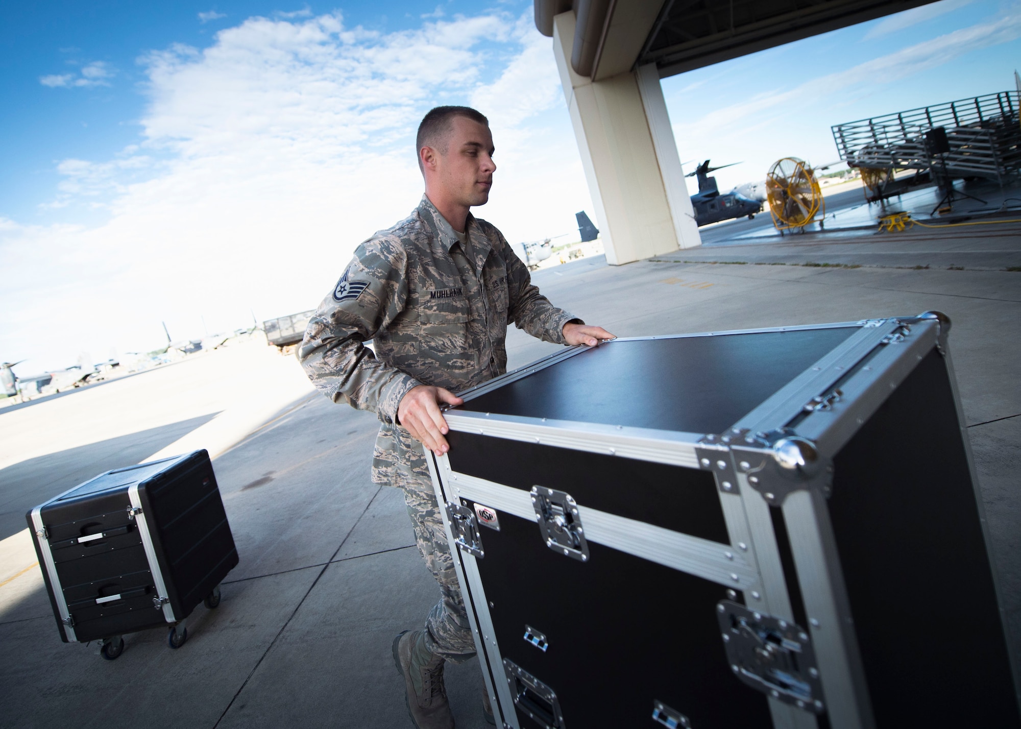 Staff Sgt. Andrew Muhlhahn, a radio frequency systems technician with the 1st Special Operations Communications Squadron, unloads audio equipment at the Freedom Hangar on Hurlburt Field, Fla., July 15, 2016. Airmen from the 1st SOCS are charged with an additional duty to setup audio systems for public address at base functions. (U.S. Air Force photo by Senior Airman Krystal M. Garrett)
