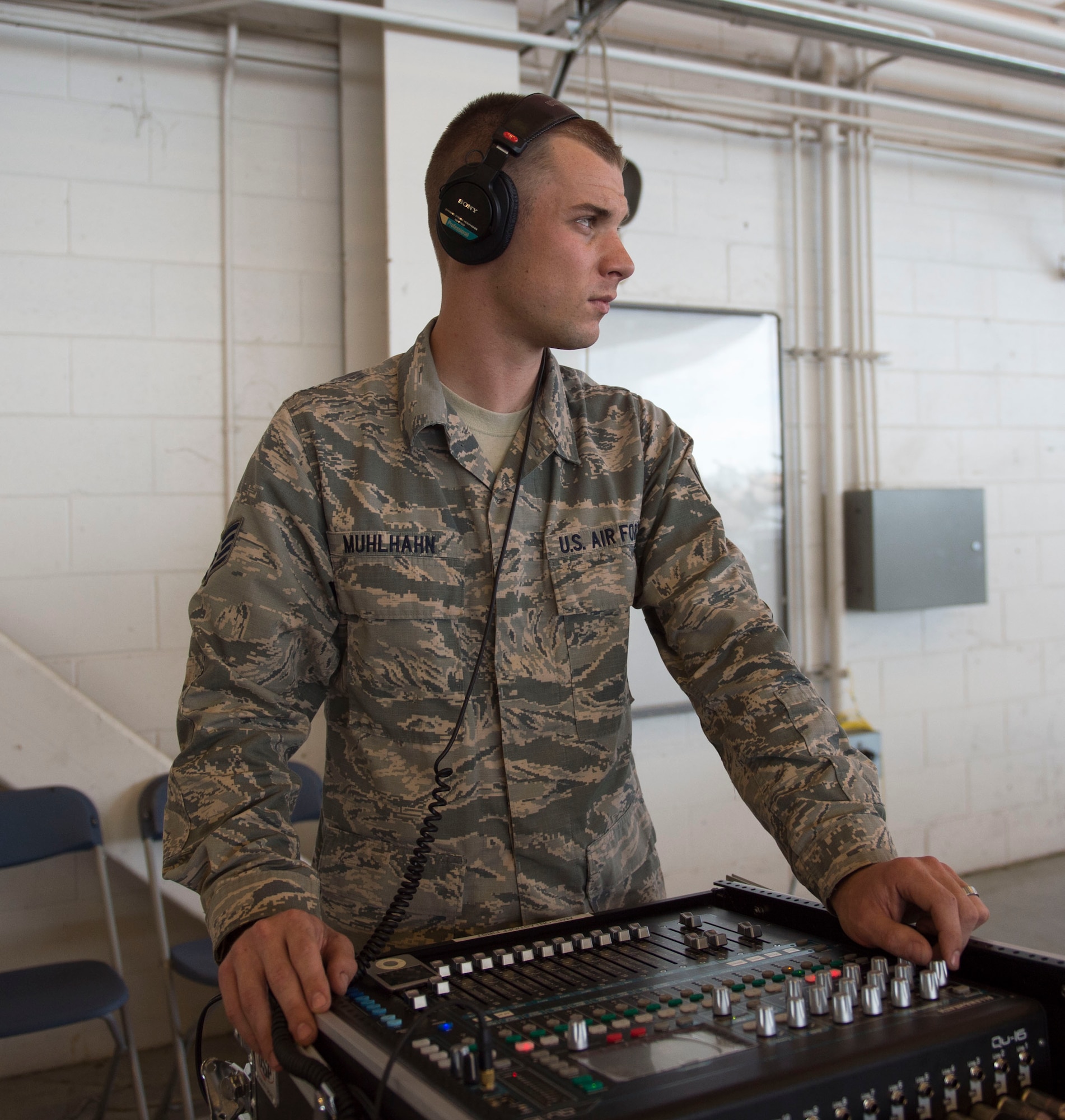 Staff Sgt. Andrew Muhlhahn, a radio frequency systems journeyman with the 1st Special Operations Communications Squadron, checks a sound production mixer prior to a change of command ceremony at the Freedom Hangar on Hurlburt Field, Fla., July 15, 2016. A sound production mixer allows volume control and other control access during an event. (U.S. Air Force photo by Senior Airman Krystal M. Garrett) 