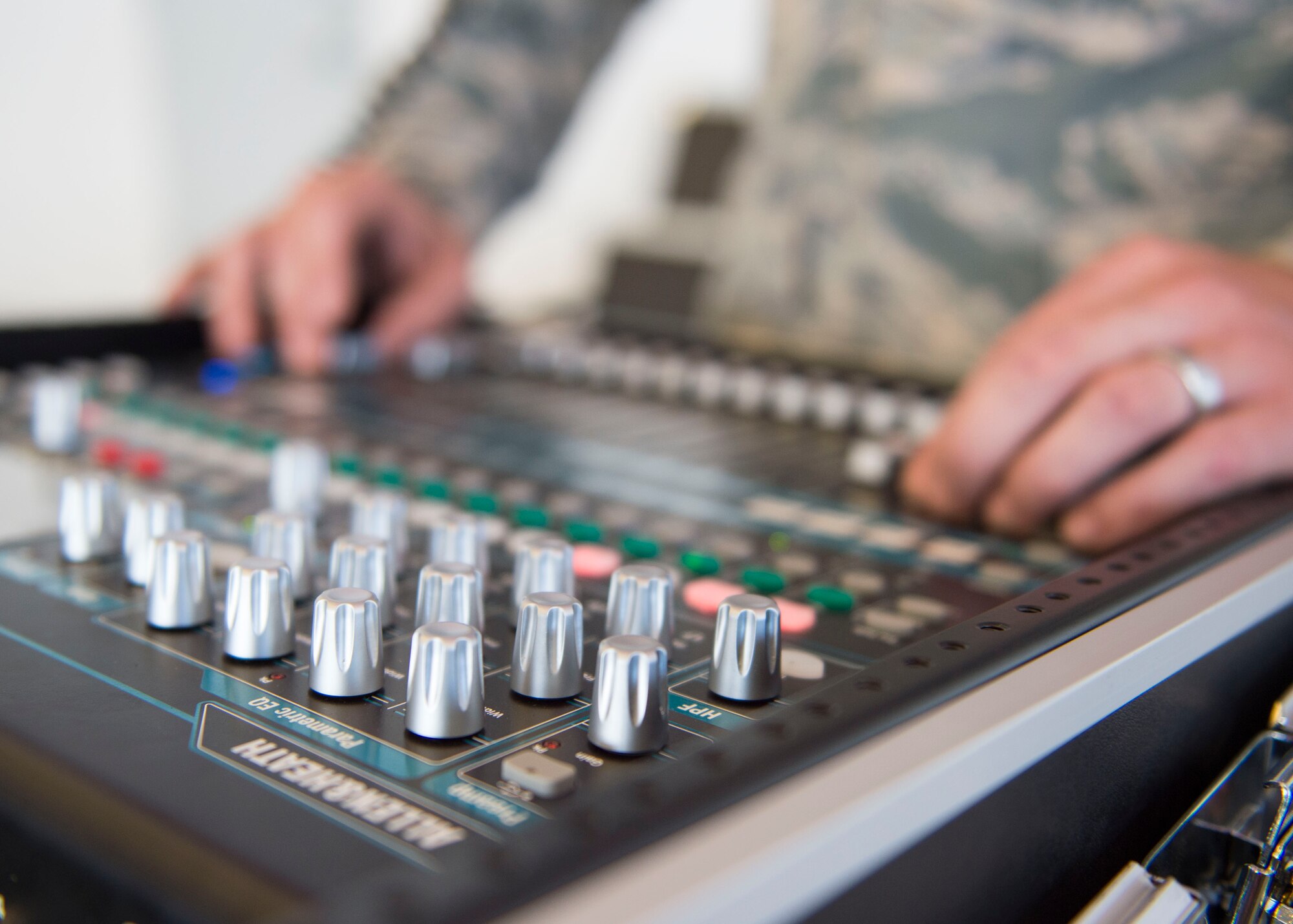Staff Sgt. Andrew Muhlhahn, a radio frequency systems journeyman with the 1st Special Operations Communications Squadron, checks a sound production mixer prior to a change of command ceremony at the Freedom Hangar on Hurlburt Field, Fla., July 15, 2016. A sound production mixer allows volume control and other control access during an event. (U.S. Air Force photo by Senior Airman Krystal M. Garrett) 