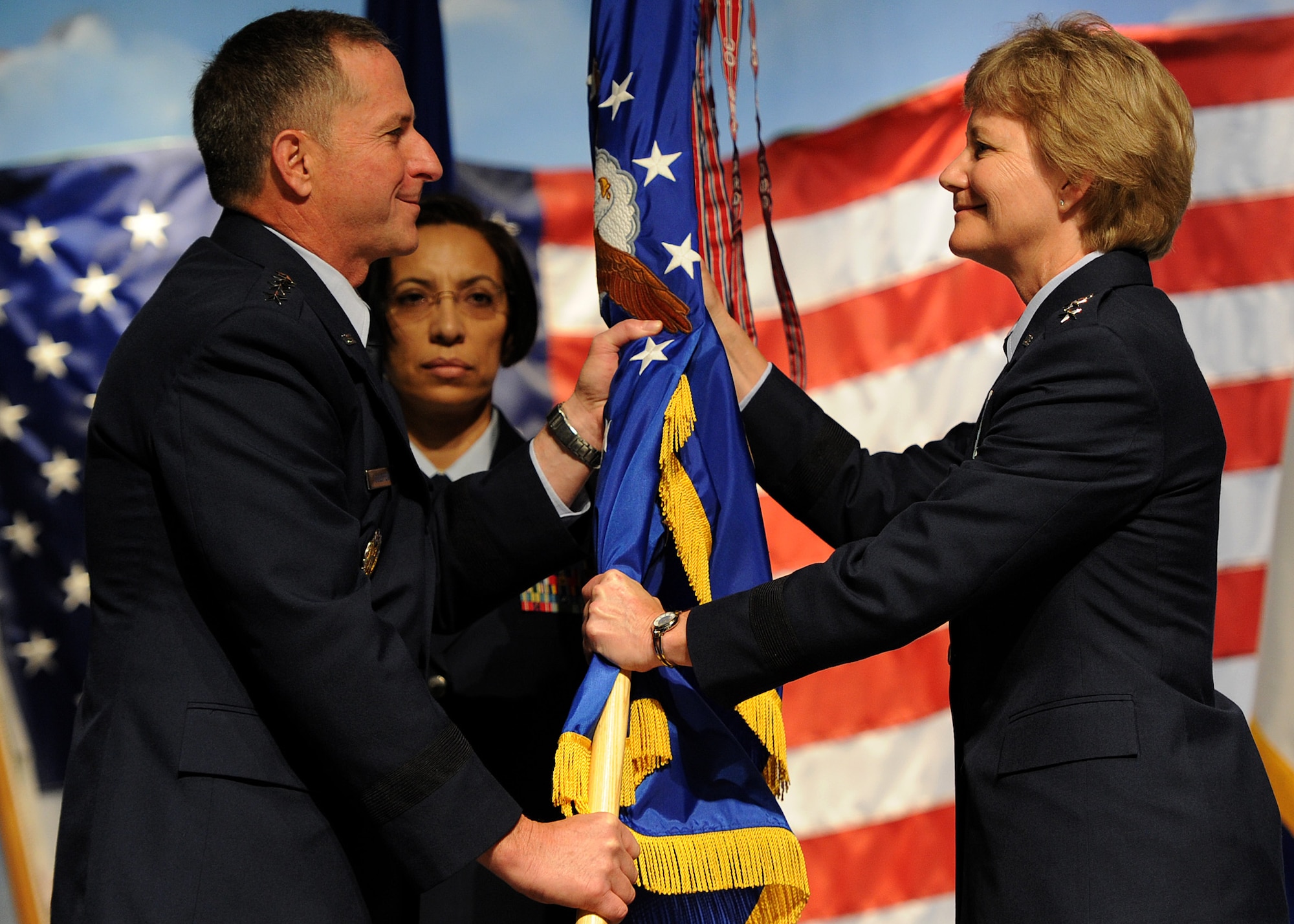 U.S. Air Force Chief of Staff, Gen. David L. Goldfein, passes the Air Force Reserve Command guidon to Lt Gen. Maryanne Miller during the AFRC change of command ceremony at the Museum of Aviation, Warner Robins, Georgia, July 15, 2016. Miller became the Air Force Reserve's first female lieutenant general and the first female Chief of the Air Force Reserve and commander of Air Force Reserve Command. (U.S. Air Force photo by Tech Sgt. Stephen D. Schester)