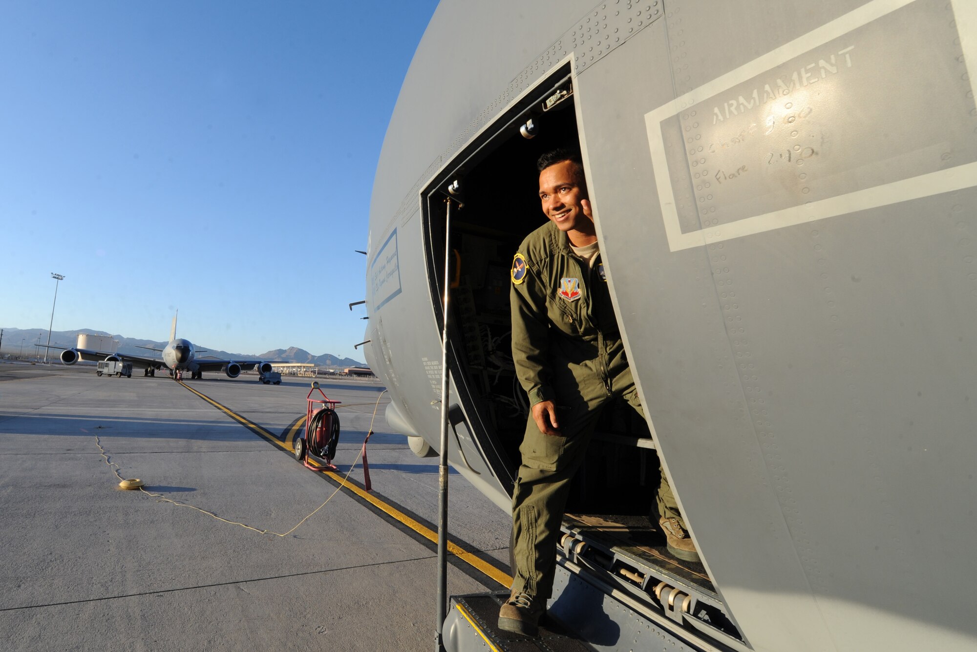 Senior Airman Frankie Harper, a loadmaster assigned to the 79th Rescue Squadron, Davis-Monthan Air Force Base, Ariz., performs pre-flight checks on an HC-130J Combat King II prior to a Red Flag 16-3 night training mission July 13, 2016 at Nellis AFB, Nev. HC-130J crews normally fly night at low to medium altitude levels in contested or sensitive environments, both over land or overwater. Crews use night vision goggles for tactical flight profiles to avoid detection to accomplish covert infiltration/exfiltration and transload operations. . (U.S. Air Force photo by Senior Airman Joshua Kleinholz/Released)