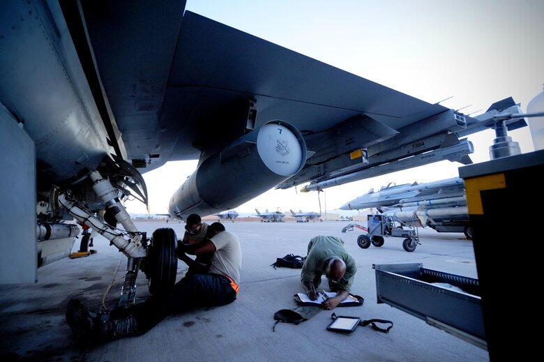 Maintainers from the 20th Aircraft Maintenance Squadron, Shaw Air Force Base, S.C., change a tire on an F-16 CJ prior to a Red Flag 16-3 night training mission July 13, 2016 at Nellis AFB, Nev. Aircraft maintainers work through the night to ensure aircrews continue to receive an effective, but most of all safe, training experience. (U.S. Air Force photo by Senior Airman Joshua Kleinholz/Released)