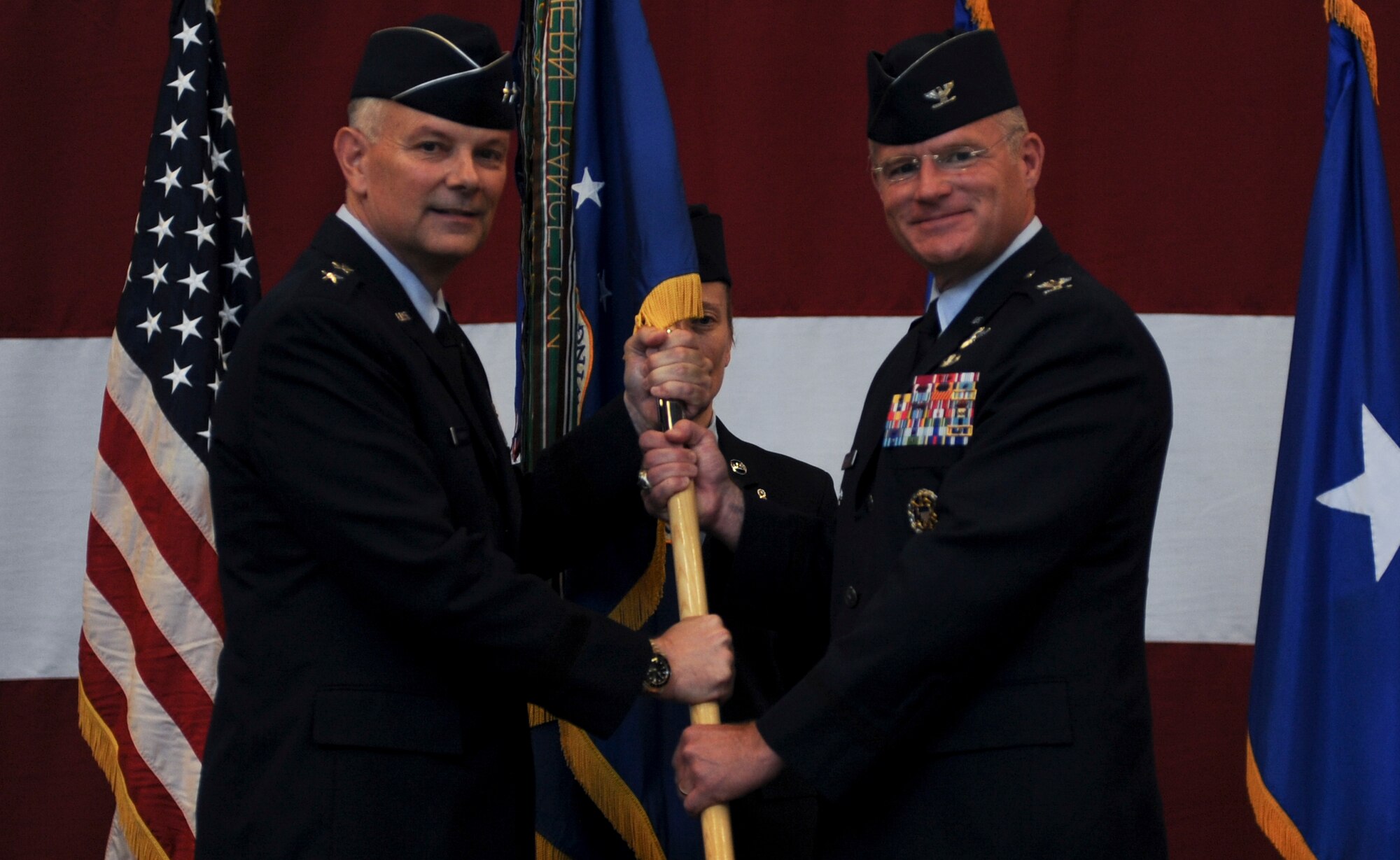 Col. Paul Murray assumes command of the 99th Air Base Wing during a ceremony held in Strike Aircraft Maintenance Unit hangar at Nellis Air Force Base, Nev., July 15, 2016. The 99th ABW provides installation support to more than 10,000 personnel assigned to Nellis Air Force Base, Creech AFB, and the Nevada Test and Training Range. (U.S. Air Force photo by Airman 1st Class Kevin Tanenbaum)