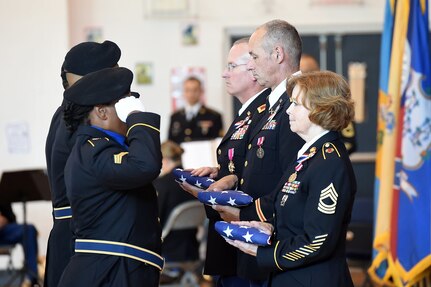 Members of the 85th Support Command Color Guard team salute folded flags in the hands of three retiring assigned to the 85th Support Command during a retirement ceremony in Arlington Heights on July 9, 2016.
 (Photo by Sgt. First Class Anthony L. Taylor)