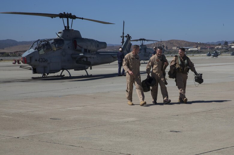 Maj. Gen. Michael Rocco (center), commanding general of 3rd Marine Aircraft Wing, Col. Michael Borgschulte (left), commanding officer of Marine Aircraft Group (MAG) 39, and an AH-1W Super Cobra pilot with Marine Light Attack Helicopter Training Squadron 303, walk away from a Cobra after Rocco’s last flight aboard Marine Corps Air Station Camp Pendleton, Calif., July 7, 2016. Rocco took command of 3rd MAW in June 2014 and is slated to relinquish command to Maj. Gen. Mark Wise on July 22, 2016. (U.S. Marine Corps photo by Pfc. Jake McClung/Released)