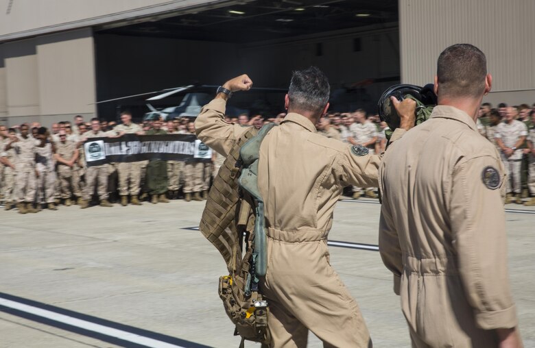 Maj. Gen. Michael Rocco, commanding general of 3rd Marine Aircraft Wing, flexes at the Marines of Marine Aircraft Group (MAG) 39 after his last flight aboard Marine Corps Air Station Camp Pendleton, Calif., July 7, 2016.  Rocco returned to every Marine in MAG-39 waiting for him on the flight line to show appreciation for his hardwork and great leadership during his two-year tour with 3rd MAW. (U.S. Marine Corps photo by Pfc. Jake McClung/Released)