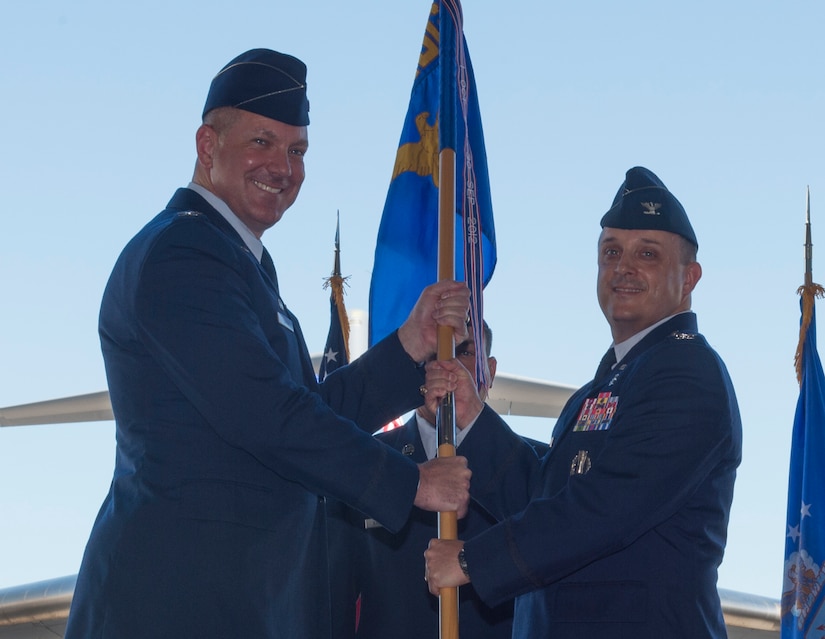 Col. Craig Lambert, 628th Medical Group commander, receives the 628th MDG guidon from Col. Robert Lyman, Joint Base Charleston commander, during a change of command ceremony in Nose Dock 2 at JB Charleston, July 14, 2016. Lambert served as the Chief, Medical Support Division and Command Administrator, Office of the Command Surgeon, Air Force Global Strike Command for Barksdale Air Force Base, La. (U.S. Air Force Photo/Airman Megan Munoz)
