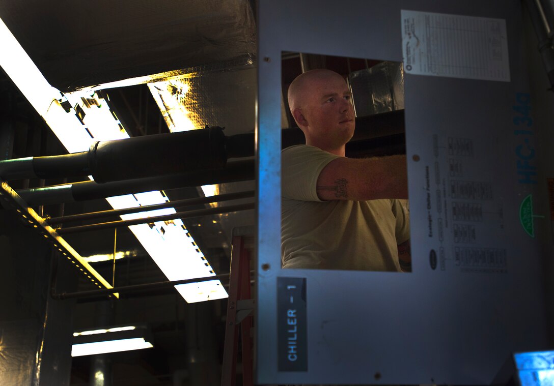 Staff Sgt. Ben Levalley, 11th Civil Engineer Squadron HVAC journeyman, repairs an air conditioning unit at the Child Development Center Three on Joint Base Andrews, Md., July 13, 2016. The HVAC flight cares for approximately 2,400 air conditioning systems throughout JBA. (U.S. Air Force photo by Senior Airman Mariah Haddenham)