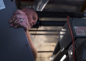 Staff Sgt. Ben Levalley, 11th Civil Engineer Squadron HVAC journeyman, repairs an air conditioning unit at the Child Development Center Three on Joint Base Andrews, Md., July 13, 2016. The HVAC flight cares for approximately 2,400 air conditioning systems throughout JBA. (U.S. Air Force photo by Senior Airman Mariah Haddenham)