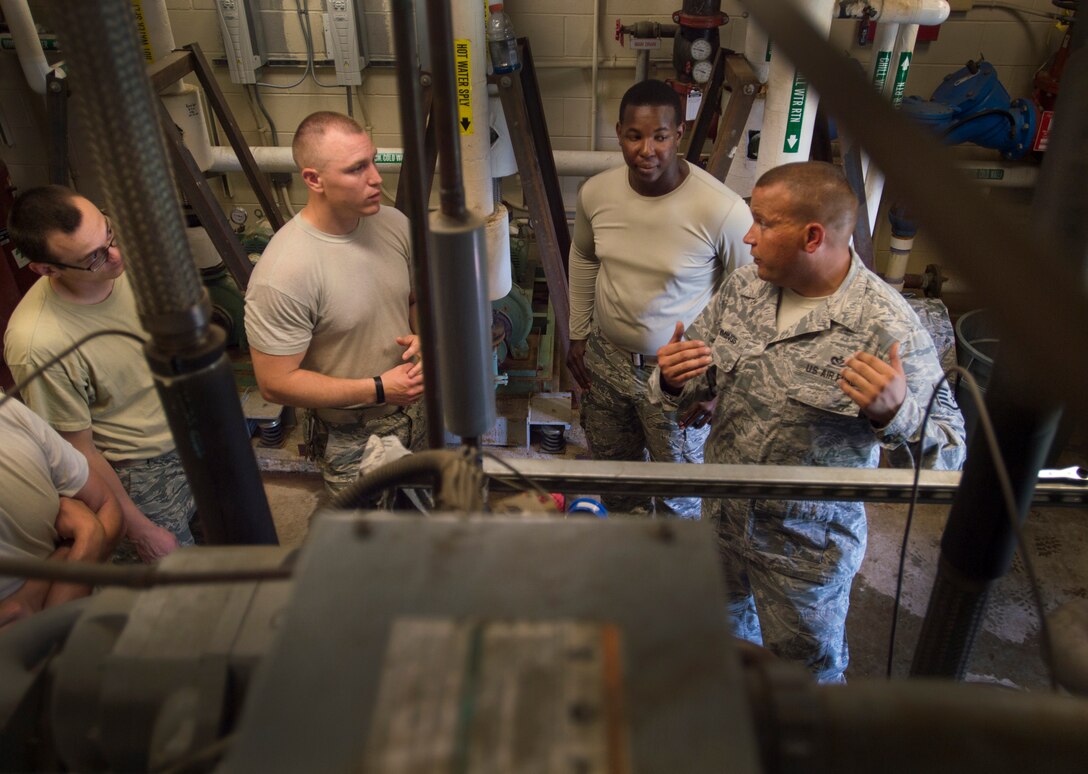 Staff Sgt. Bryan Cummings, 11th Civil Engineer Squadron HVAC craftsman, teaches other airmen while repairing an air conditioning unit at the Child Development Center Three on Joint Base Andrews, Md., July 13, 2016. The HVAC flight cares for approximately 2,400 air conditioning units throughout JBA. (U.S. Air Force photo by Senior Airman Mariah Haddenham)