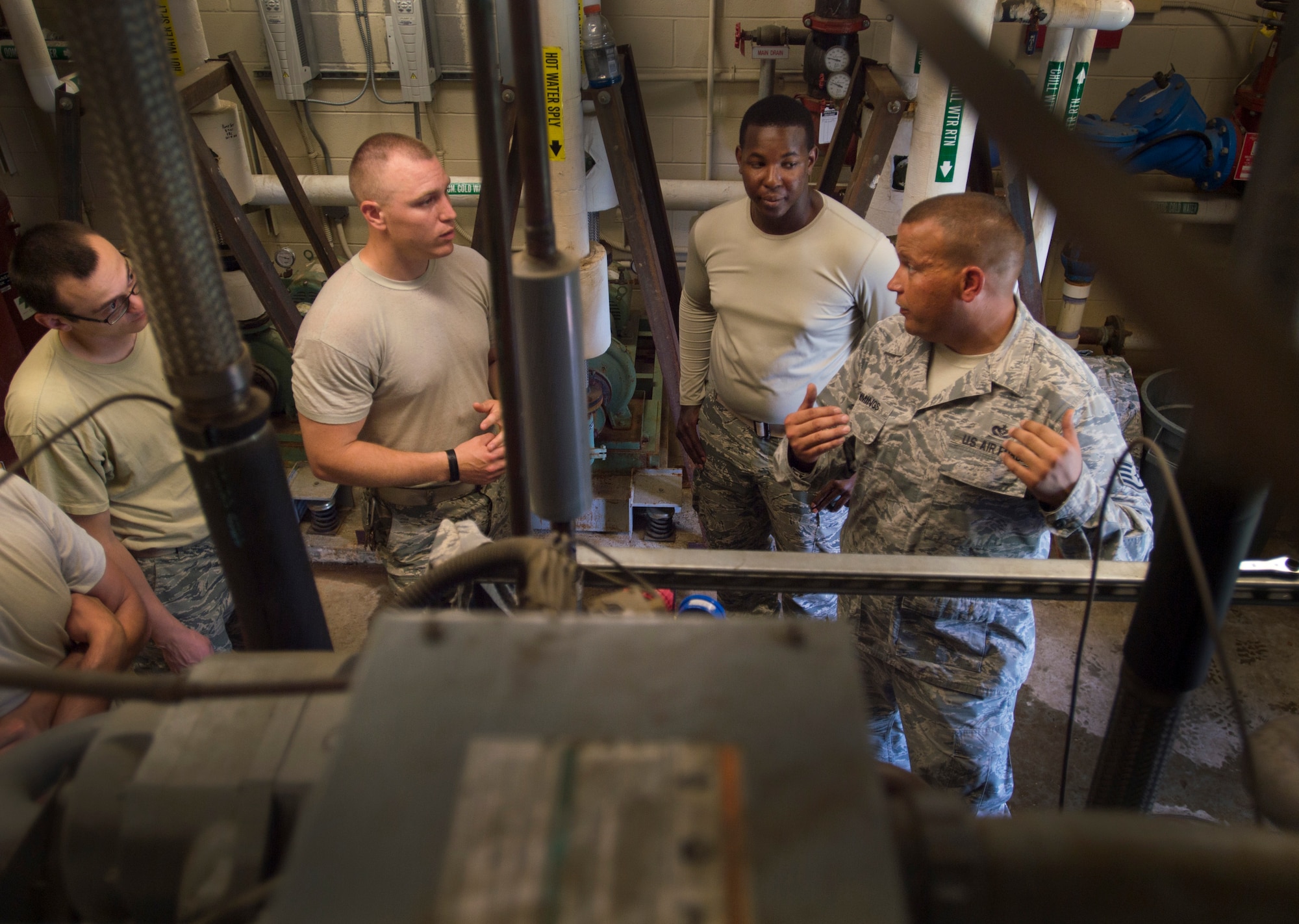 Staff Sgt. Bryan Cummings, 11th Civil Engineer Squadron HVAC craftsman, teaches other airmen while repairing an air conditioning unit at the Child Development Center Three on Joint Base Andrews, Md., July 13, 2016. The HVAC flight cares for approximately 2,400 air conditioning units throughout JBA. (U.S. Air Force photo by Senior Airman Mariah Haddenham)