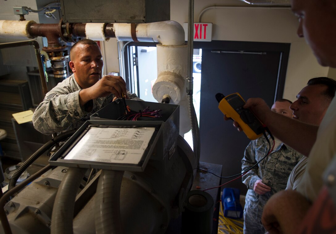 Staff Sgt. Bryan Cummings, 11th Civil Engineer Squadron HVAC craftsman, repairs an air conditioning unit at the Child Development Center Three on Joint Base Andrews, Md., July 13, 2016. The HVAC flight cares for approximately 2,400 air conditioning units throughout JBA. (U.S. Air Force photo by Senior Airman Mariah Haddenham)