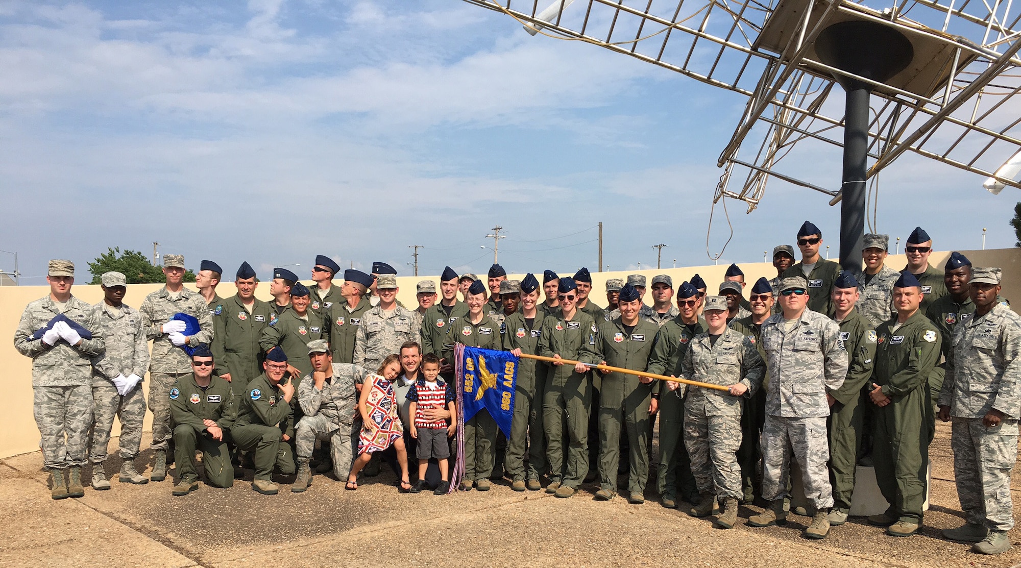 Current and former members of the 960th Airborne Air Control Squadron, along with members of the Tinker Honor Guard, gather at the Wright Flyer memorial following a special military retreat service honoring past, present and future members of the 960th that concluded the unit’s 15-year anniversary celebration July 1. (Air Force photo)