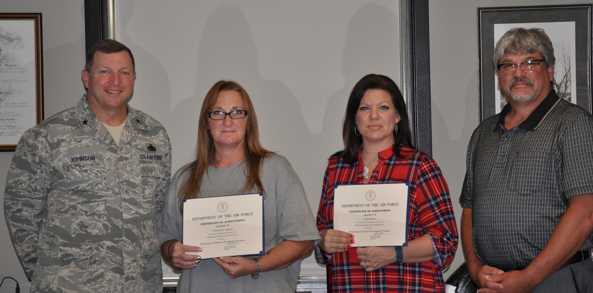 Brig. Gen. Mark Johnson, Oklahoma City Air Logistics Complex commander, left, congratulated Christina Johnson and Erin Marinko July 12 for being the first OC-ALC employees to complete all requirements in the GS-series Maintenance Workforce Development Program. Their supervisor, Marshall Riley, was also honored for providing the leadership and resources needed for them to obtain the technical skills needed to further enhance the 551st Commodities Maintenance Squadron’s mission capabilities. (Air Force photo)