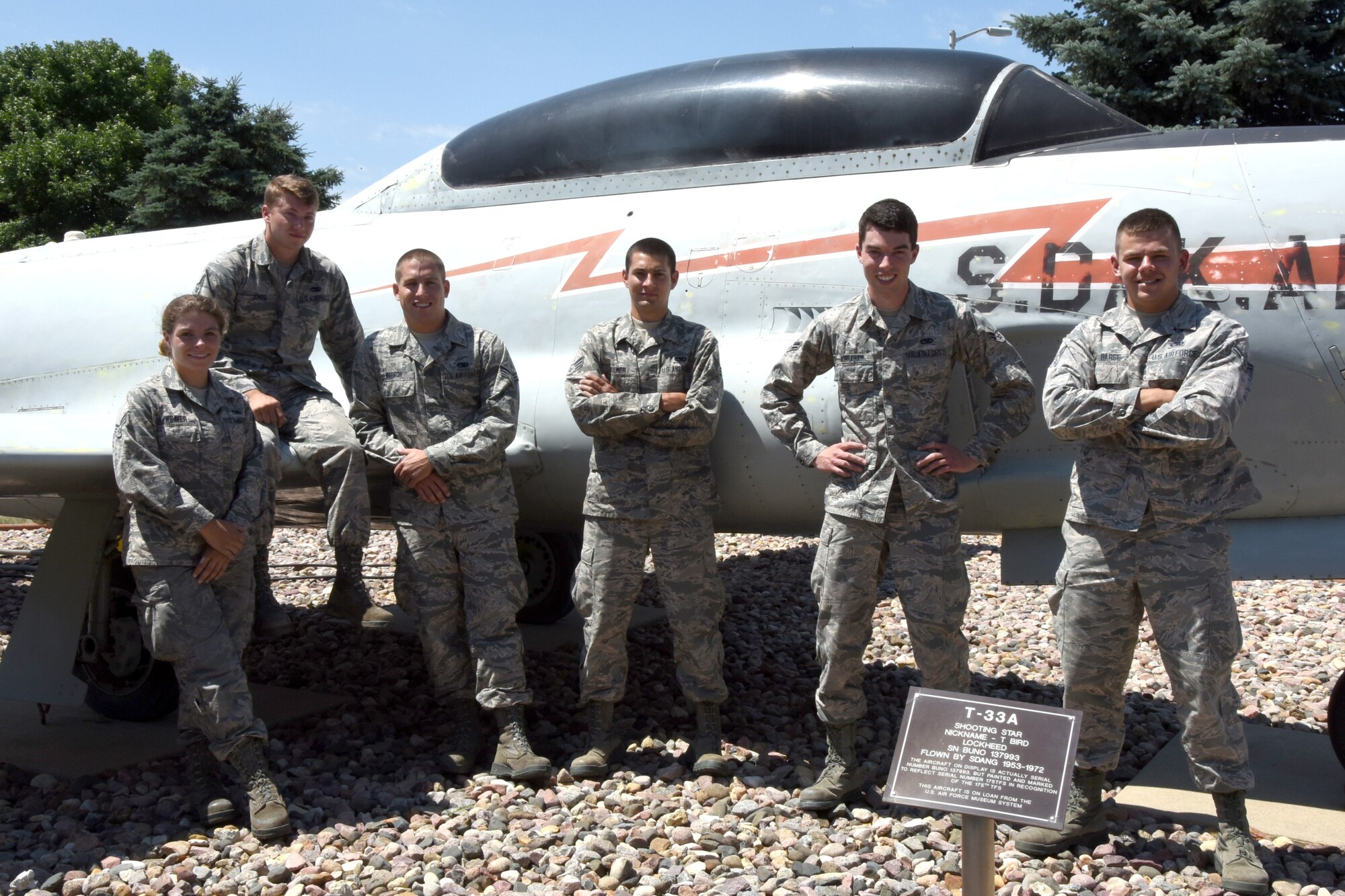 SIOUX FALLS, S.D. - Five Airmen from the 114th Maintenance Group are taking on the task of giving the static displays at Joe Foss Field, S.D. new life this year as they sand and repaint the old aircraft that are a part of the unit's great heritage.  Those Airmen are, pictured left to right; Senior Airman Constance Weaver, Senior Airman Nicholas Jones, Senior Airman Adam Watson, Senior Airman Jake Vollmer, Airman First Class Dylan Abraham,  Airman First Class Cody Barse.(U.S. Air National Guard photo by Senior Master Sgt. Nancy Ausland/released)